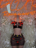 Black two-piece dancewear set with mesh top, heart pins, and layered mini skirt