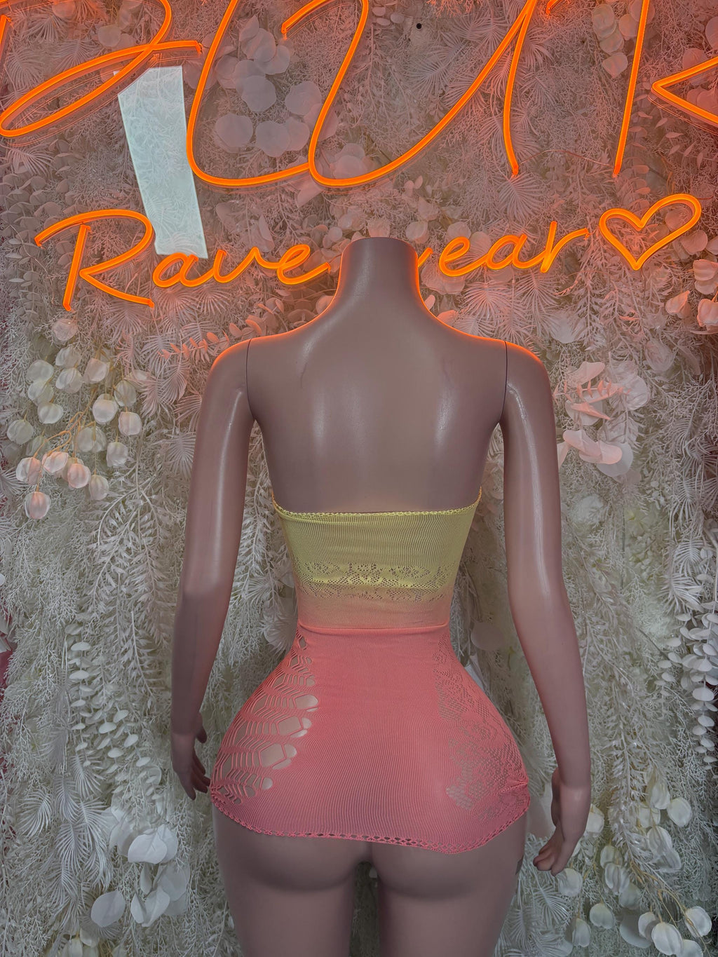 Pink mesh fishnet dress back with yellow trim and multicolor pinned charms