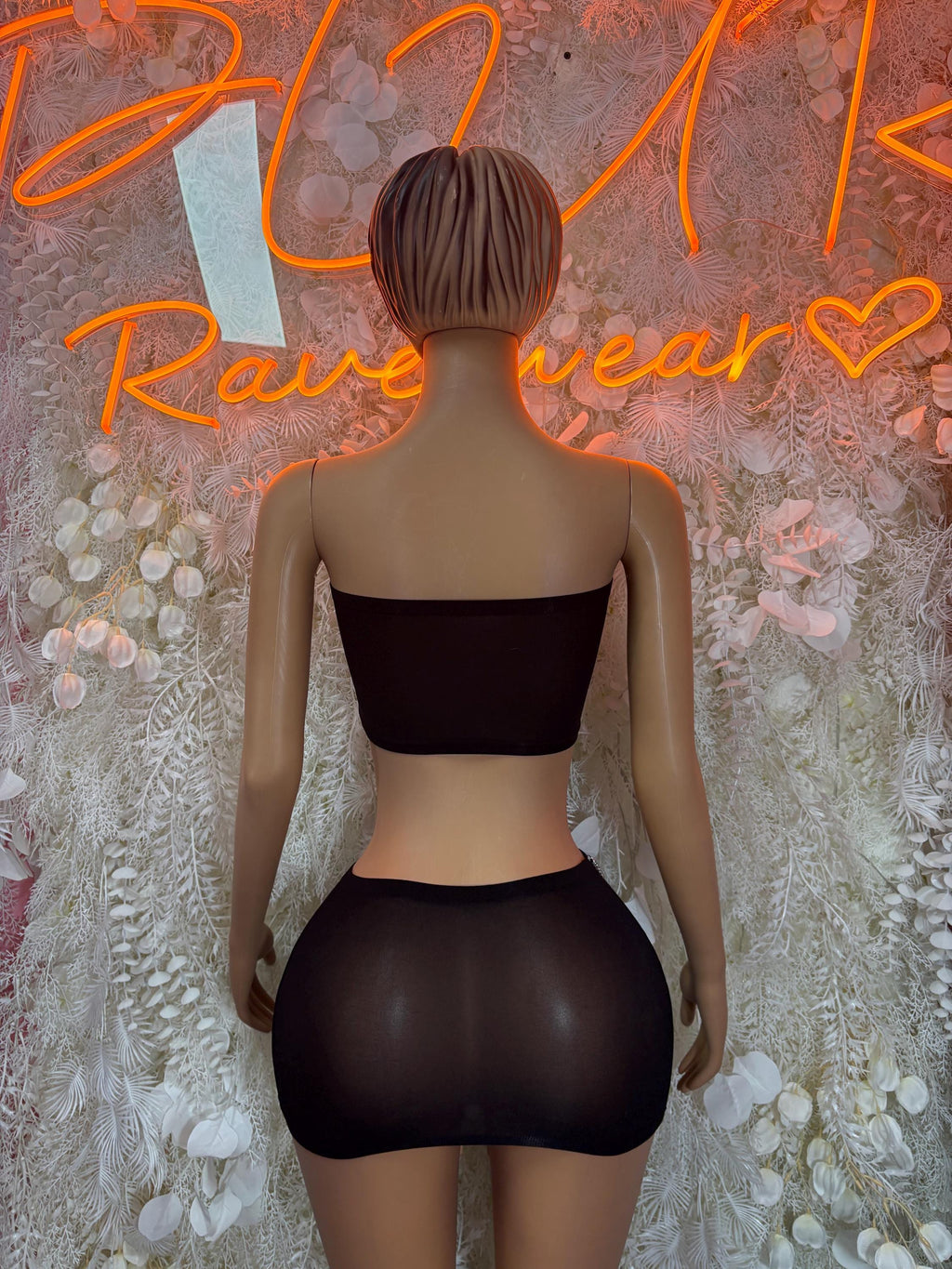 Black backless bandeau top with high-waist bottoms, small seam detail at the waist.