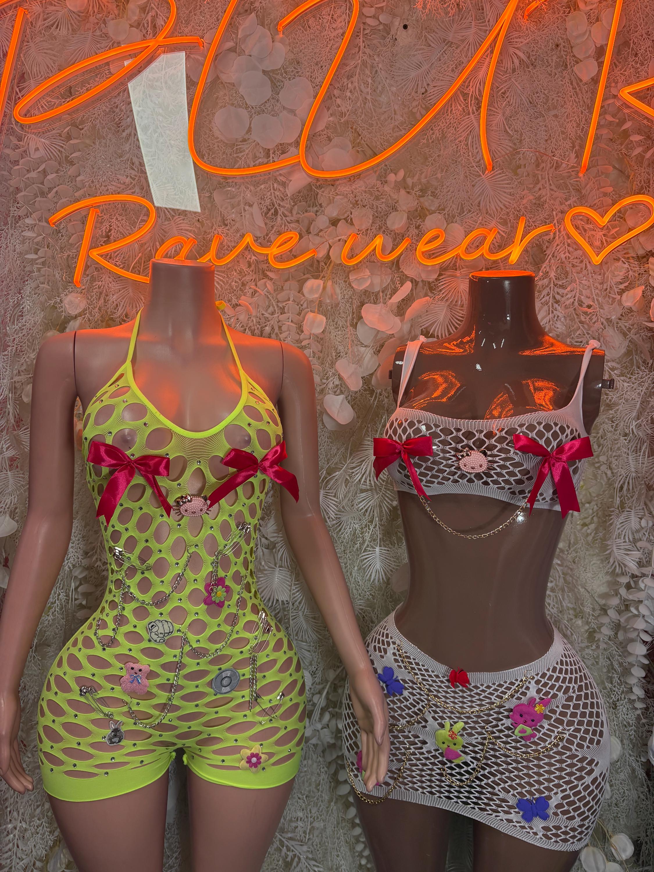 Two fishnet two-piece dance sets on mannequins: neon green and white with bows