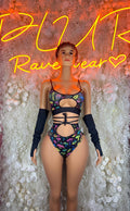 Two-piece rave swim set with multicolor mushroom print, strappy top, black arm warmers