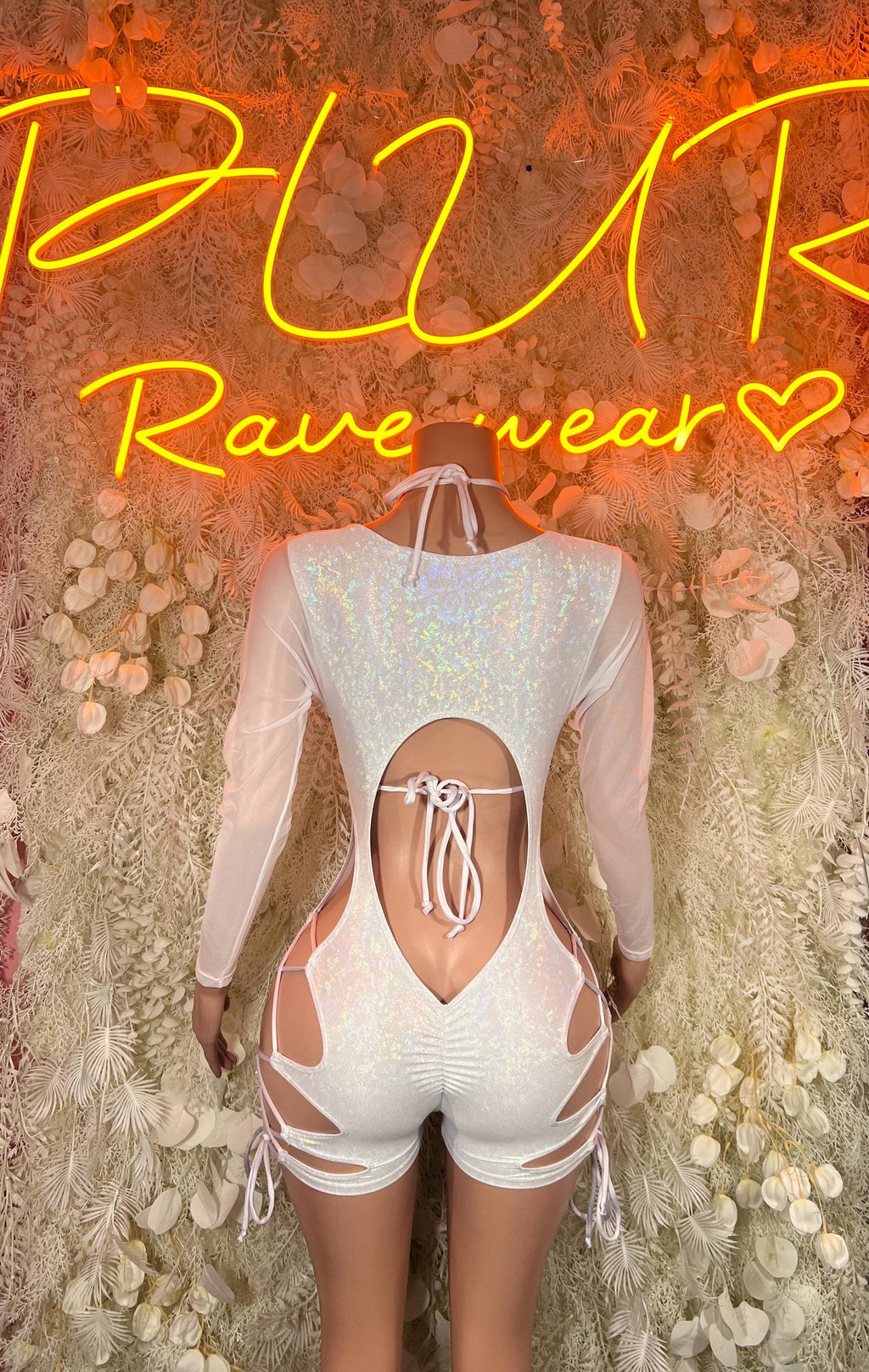 Metallic white bodysuit with open back, tanga-style lace tie and long sleeves.