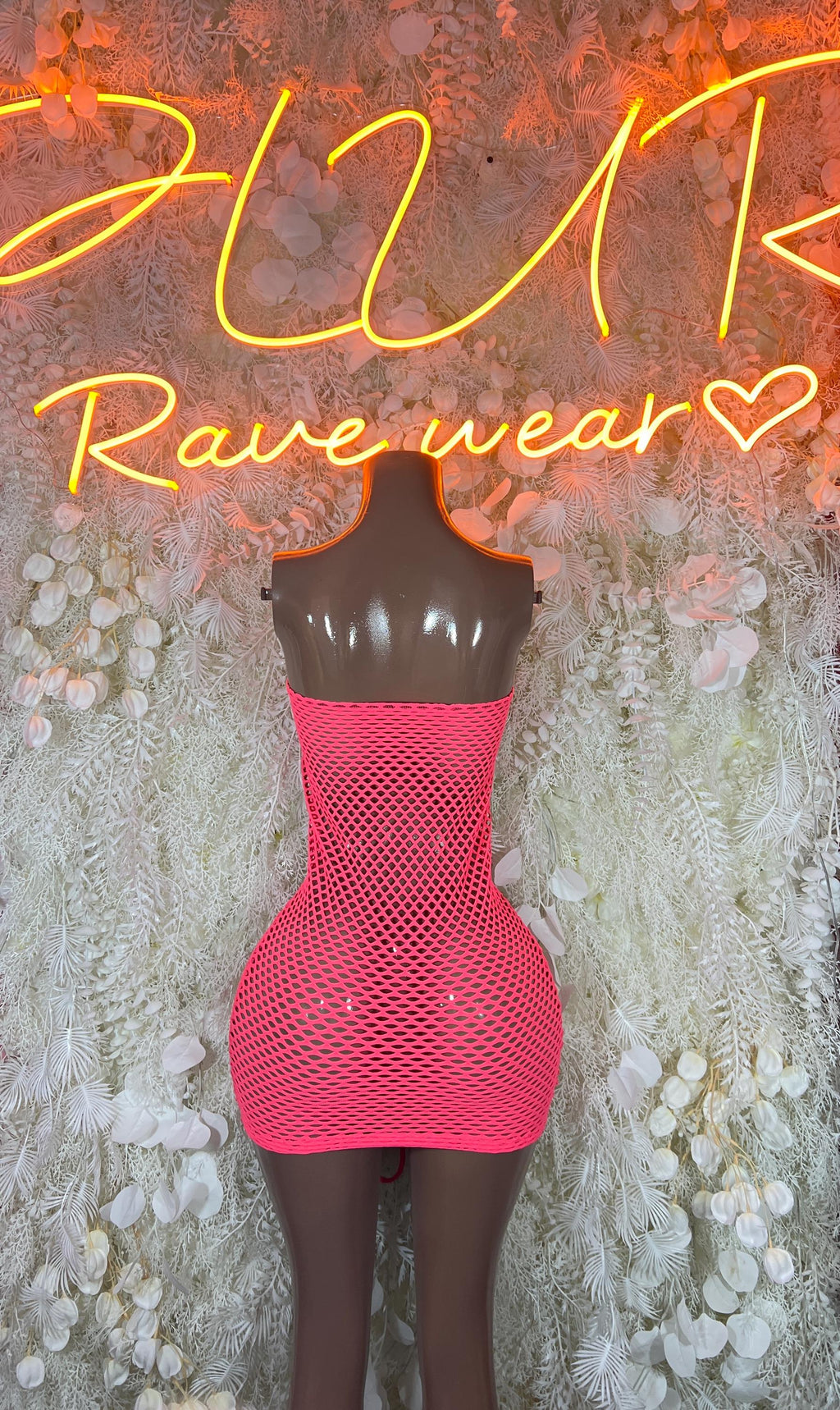 Pink fishnet mini dress on mannequin, scoop neck and lace-up panel