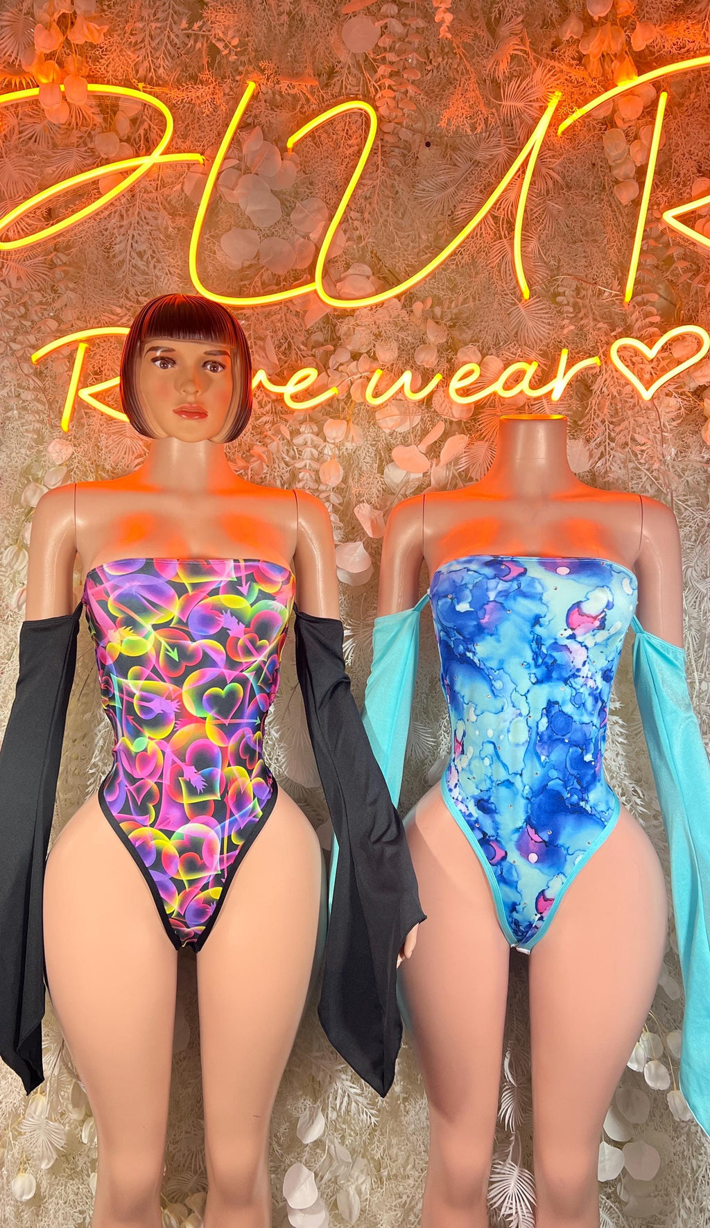 Pair of strapless high-cut neon bodysuits with purple and blue swirls