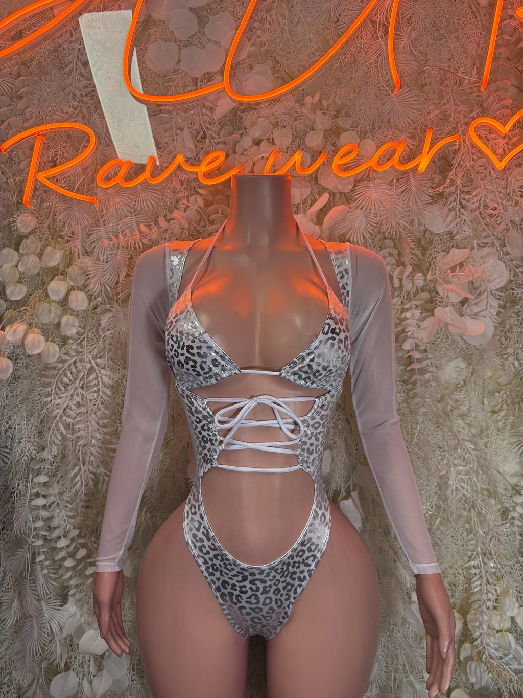Holographic silver cheetah print rave bodysuit with lace-up front and high-cut leg