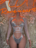 Holographic silver cheetah print rave bodysuit with lace-up front and high-cut leg