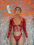Red lace bodysuit with long sleeves, lace-up front, and thong-style cut