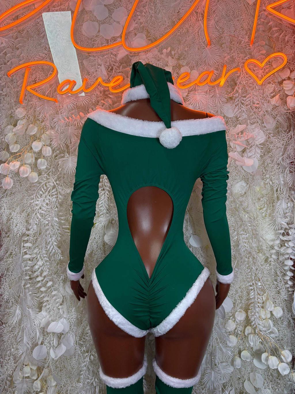 Green elf bodysuit with white collar and pom-pom, long sleeves, and lace-up front