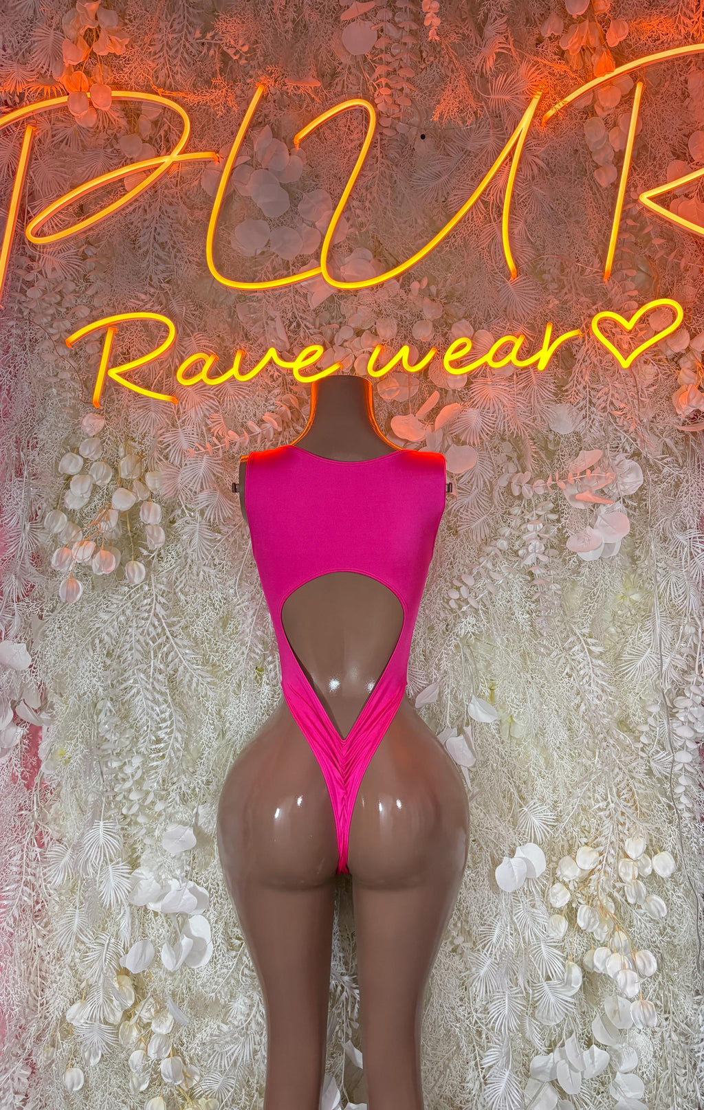 Pink open-back bodysuit with high-cut legs and wide straps