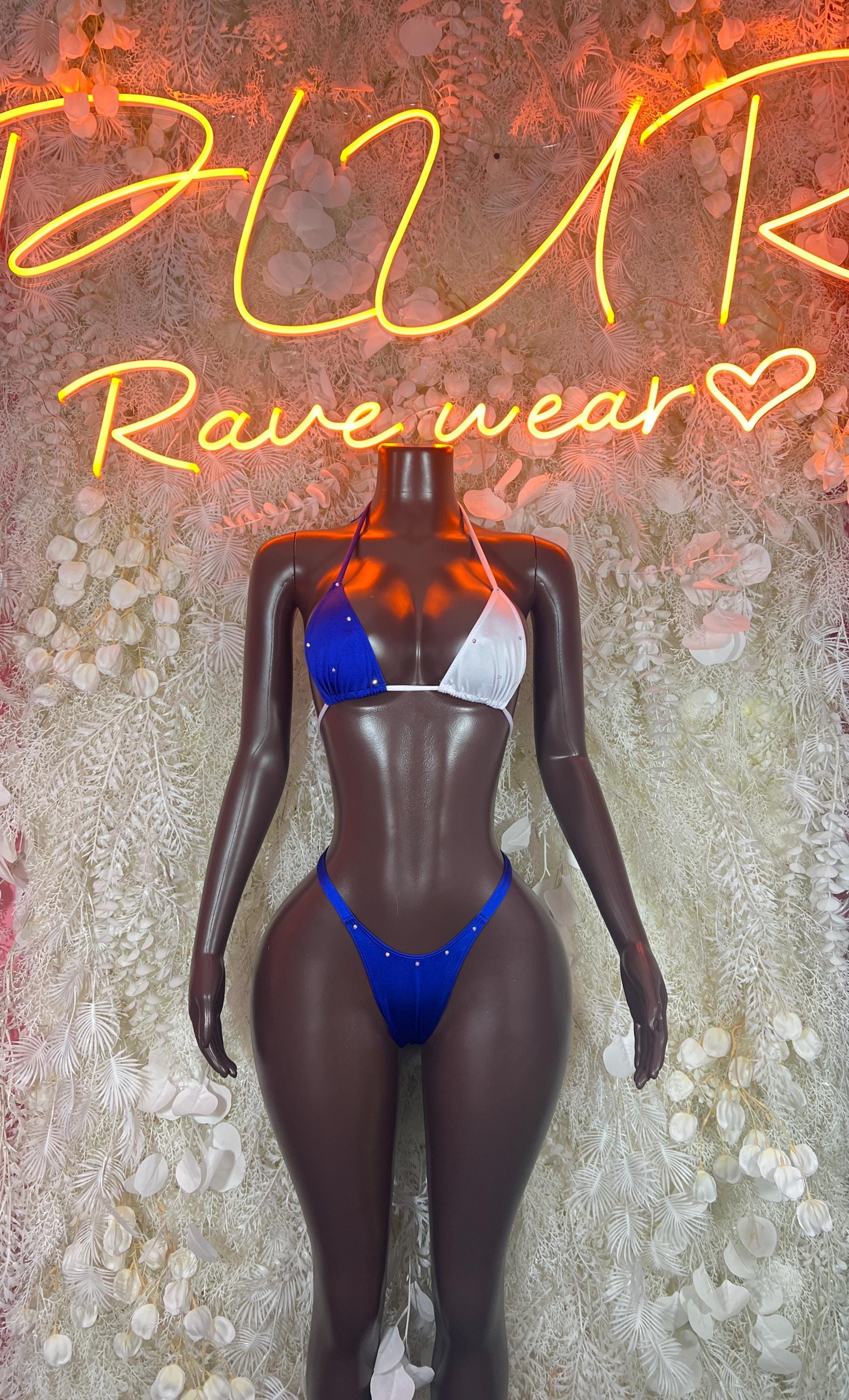 Blue two-piece bikini set on black mannequin, triangle top and string-tie bottoms