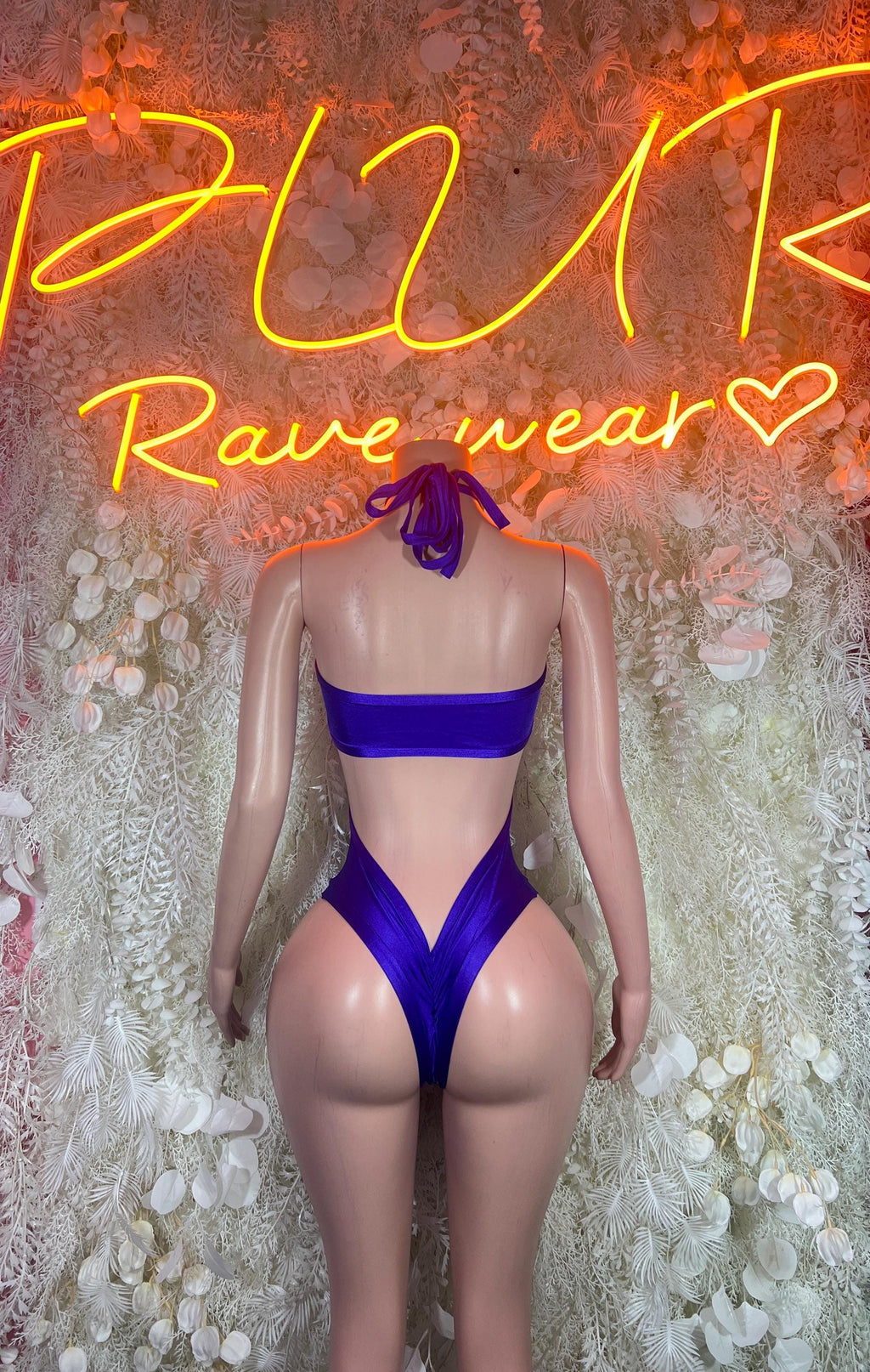 Purple high-cut bodysuit with back crisscross straps and strapless top