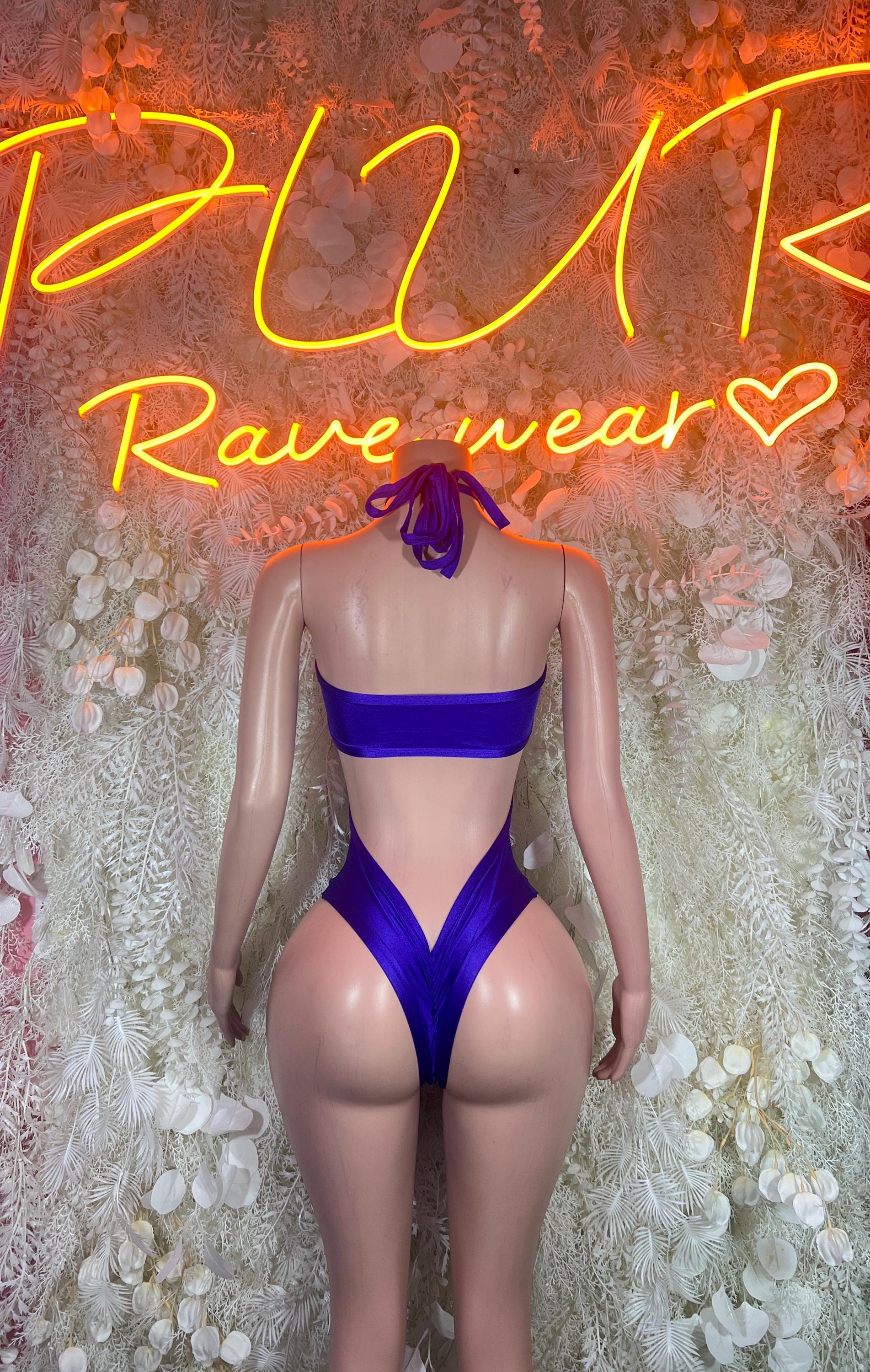 Purple high-cut bodysuit with back crisscross straps and strapless top
