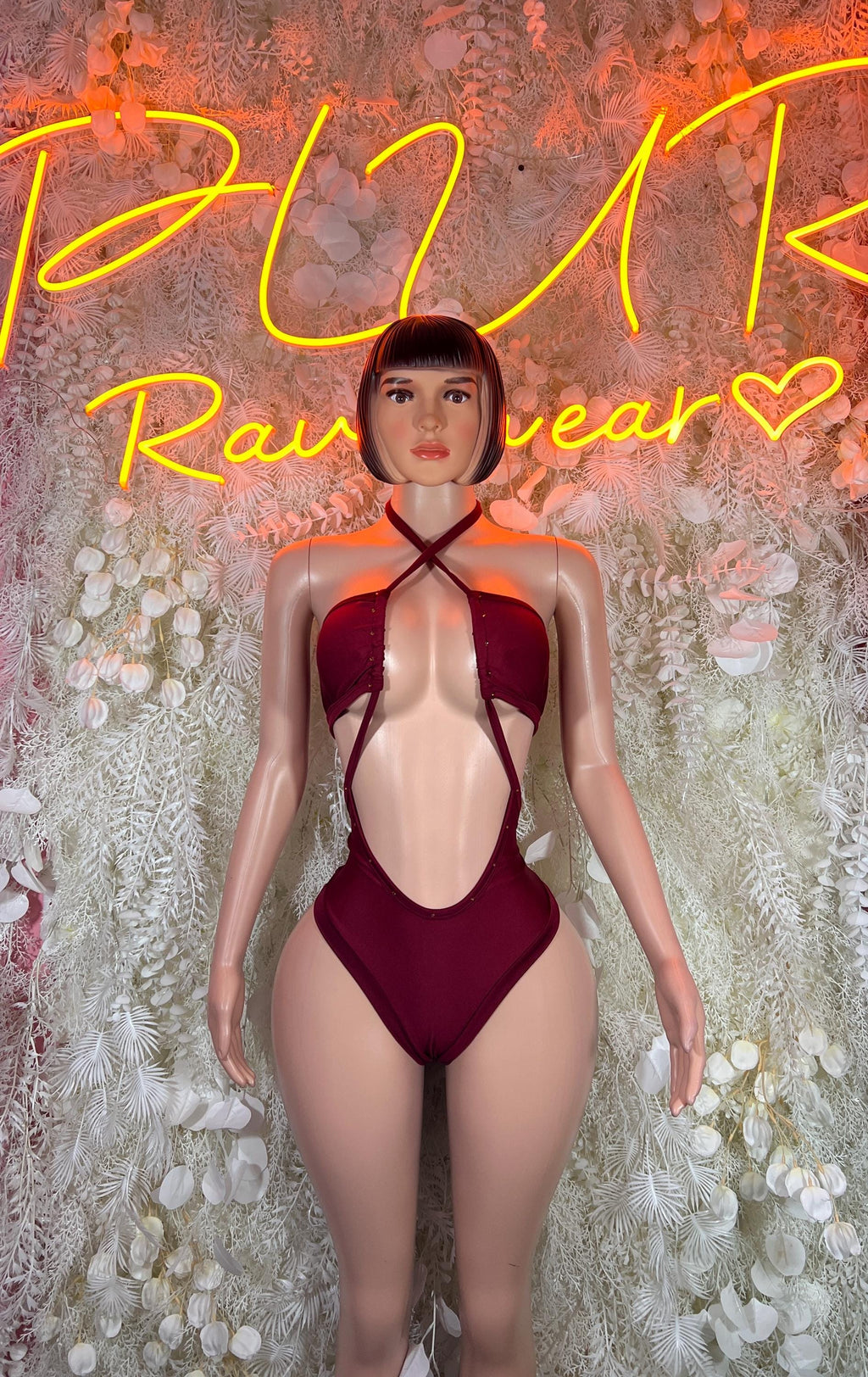 Burgundy rave bodysuit with black crisscross straps and halter neckline