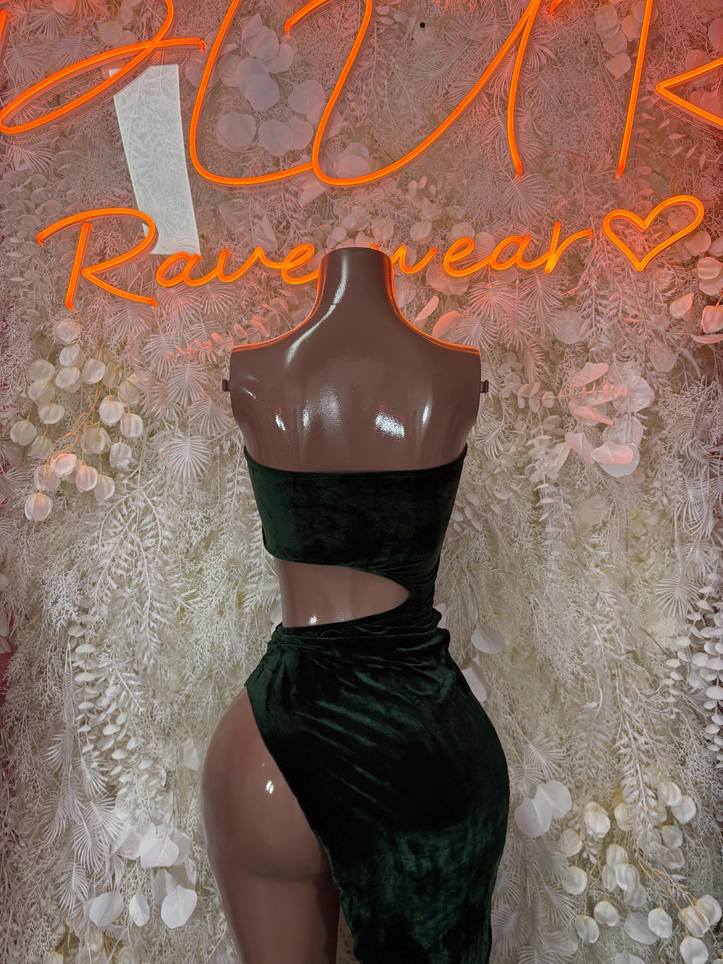 Dark green velvet dance gown with waist cutout, strapless bodice, and high-leg slit
