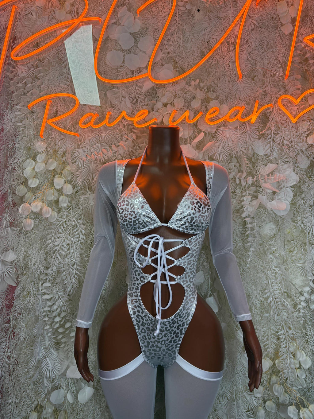 Silver cheetah-print bodysuit with long sleeves, lace-up front, and high-cut leg openings