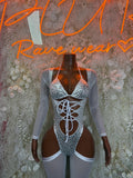 Silver cheetah-print bodysuit with long sleeves, lace-up front, and high-cut leg openings