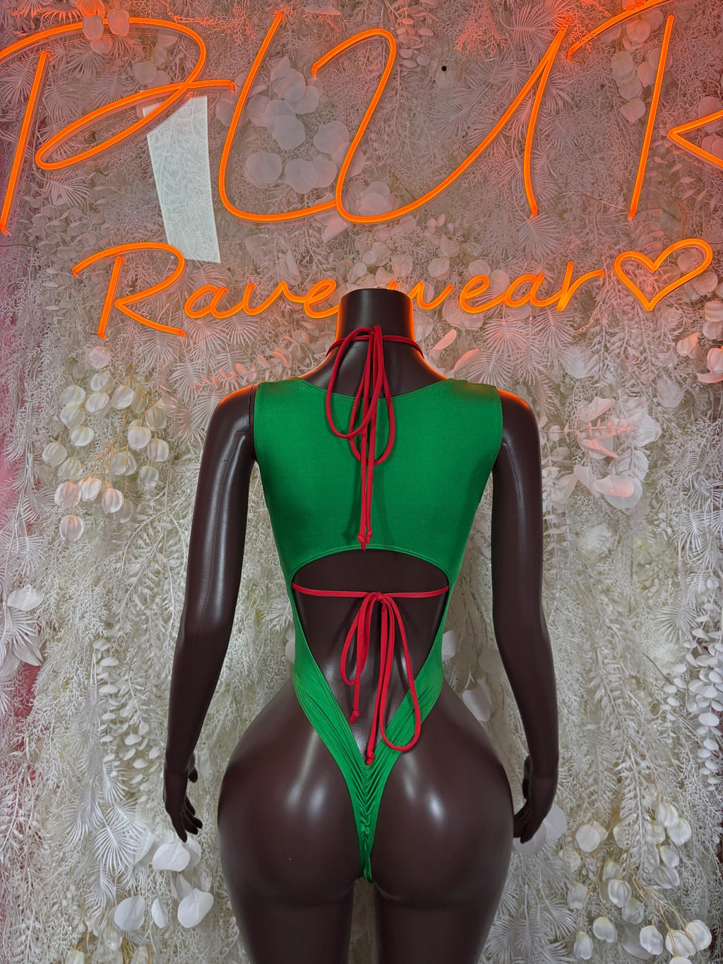 Green open-back bodysuit with tie lacing across the back and low-cut legs