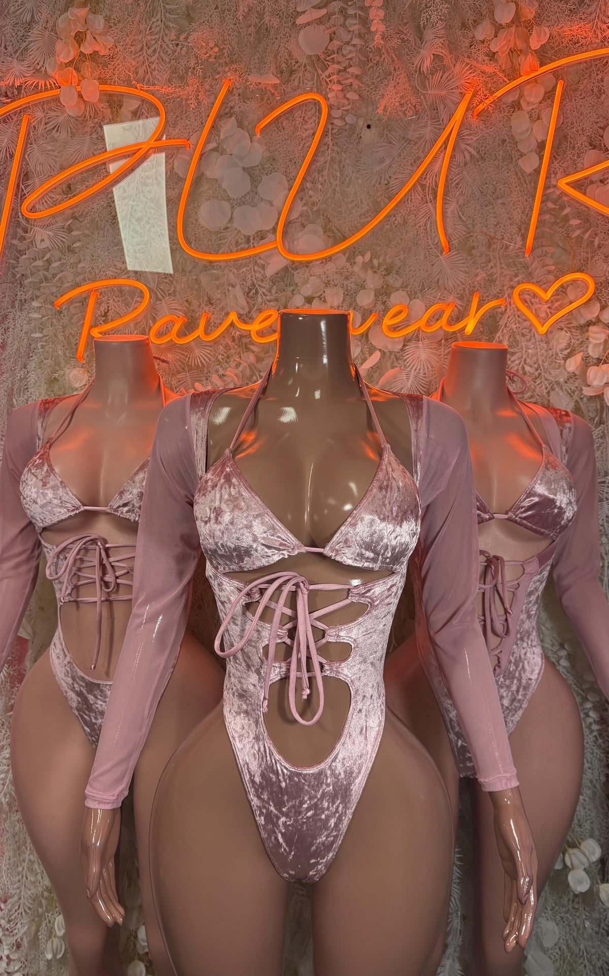 Rose pink velvet bodysuit with long sleeves, metallic silver cups, and center lace-up