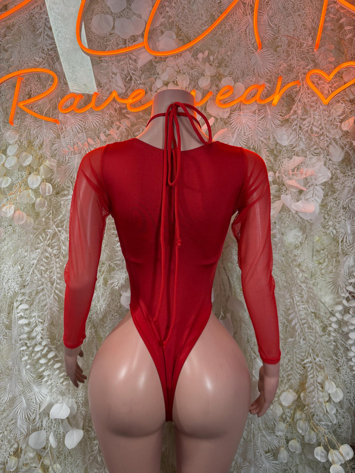 Red long-sleeve Santa-style bodysuit with open back and neck tie