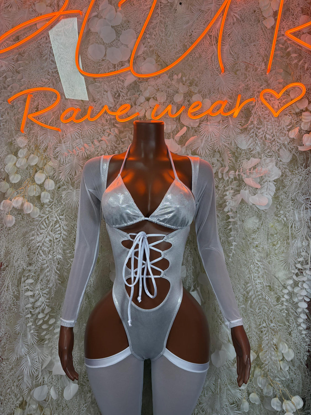 Silver metallic bodysuit with long sheer sleeves, front lace-up and thong cutout