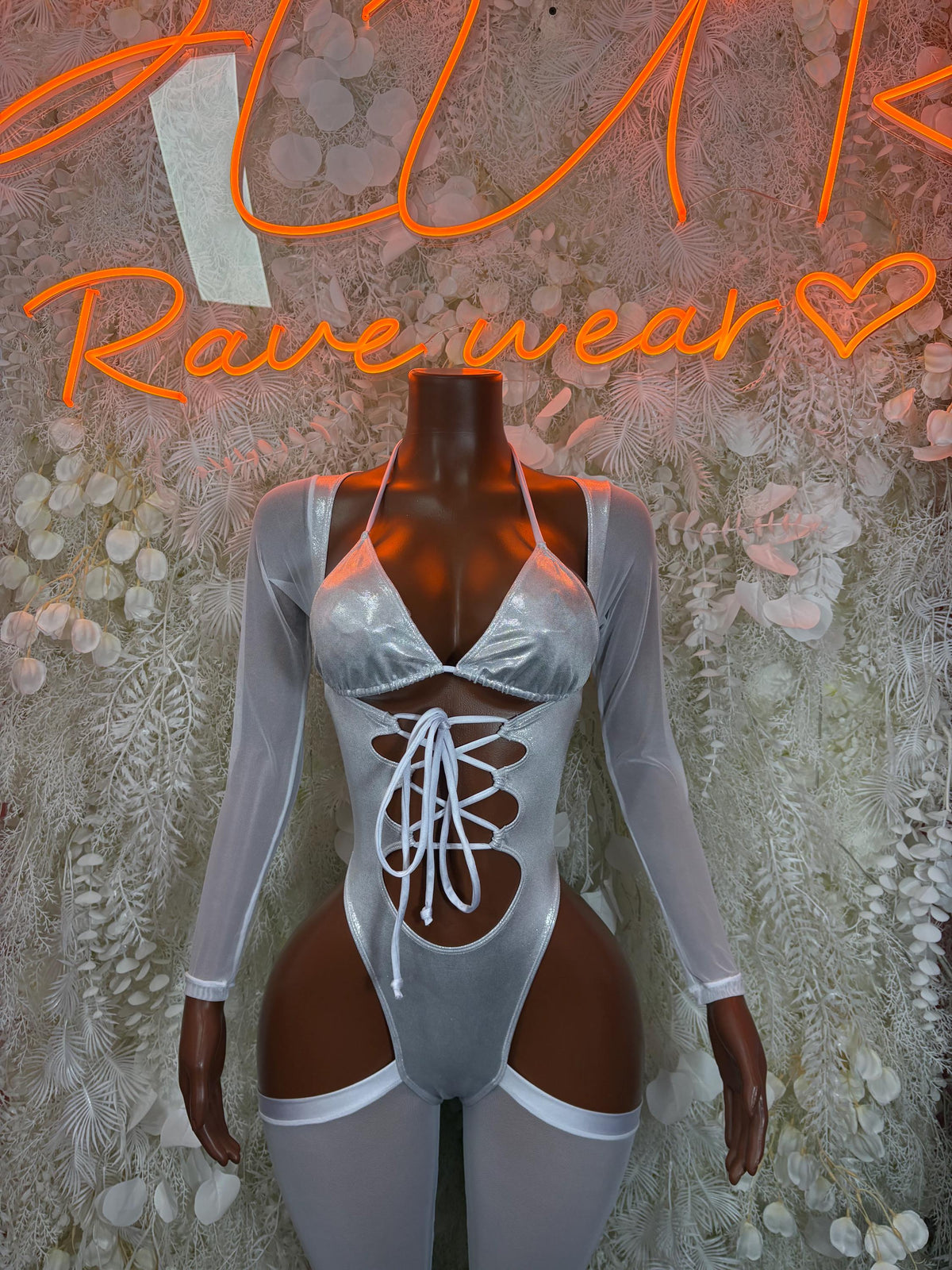 Silver metallic bodysuit with long sheer sleeves, front lace-up and thong cutout