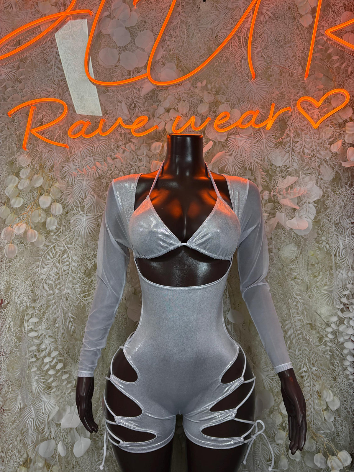 Silver metallic bodysuit with long sleeves, cutout cups, and strappy front