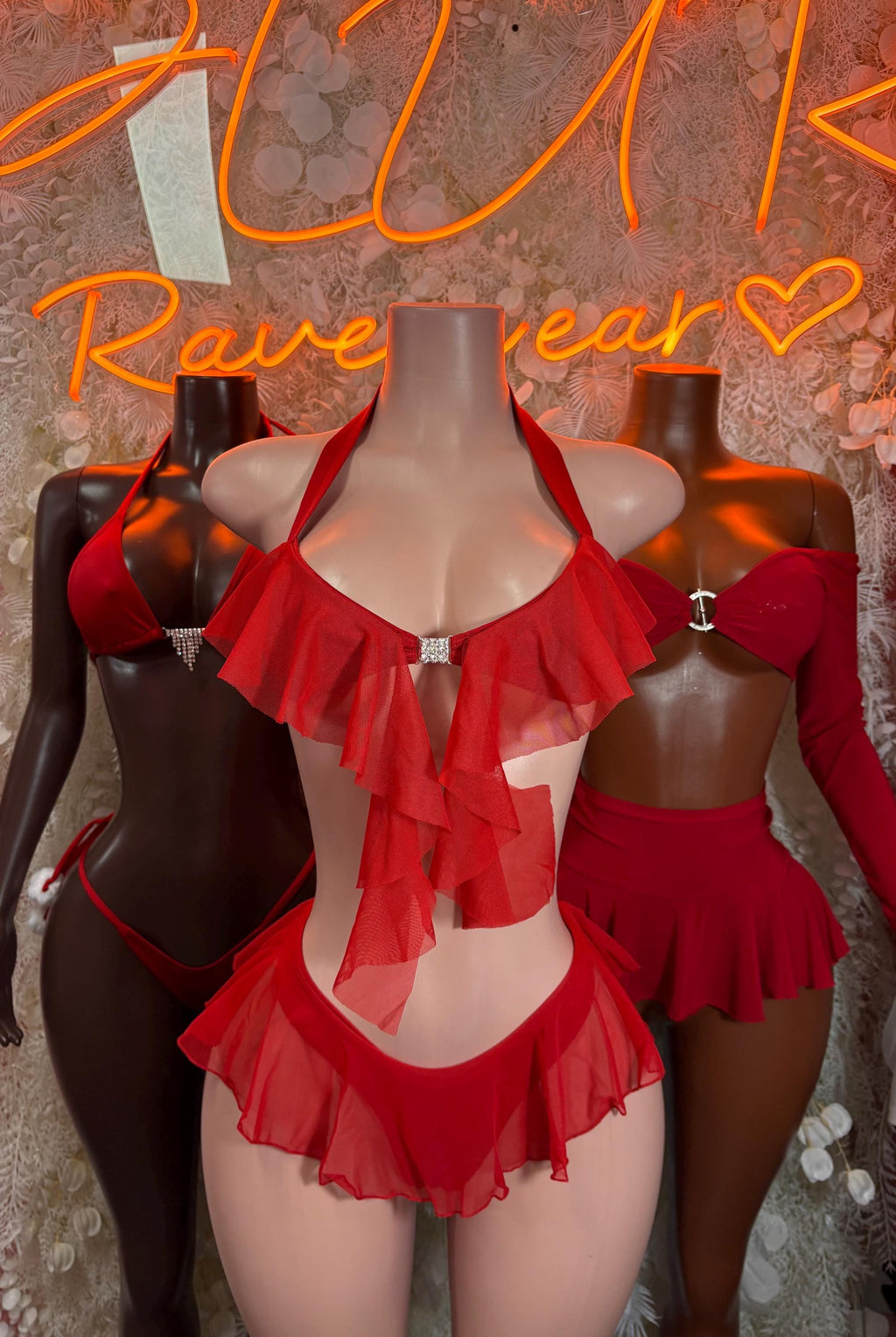 Red ruffled bikini set with triangle bra and layered skirted briefs on dark mannequin
