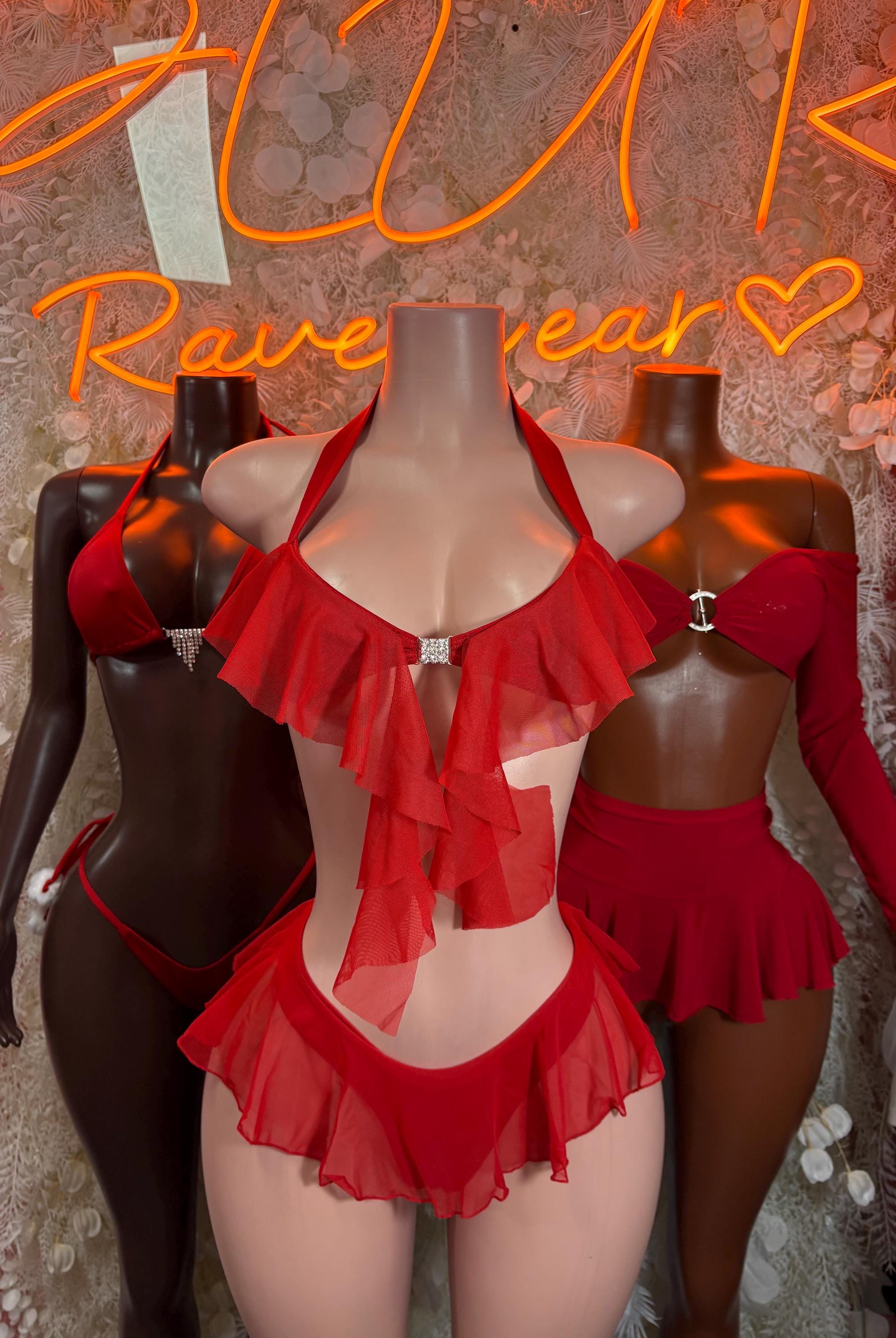 Red ruffled bikini set with triangle bra and layered skirted briefs on dark mannequin