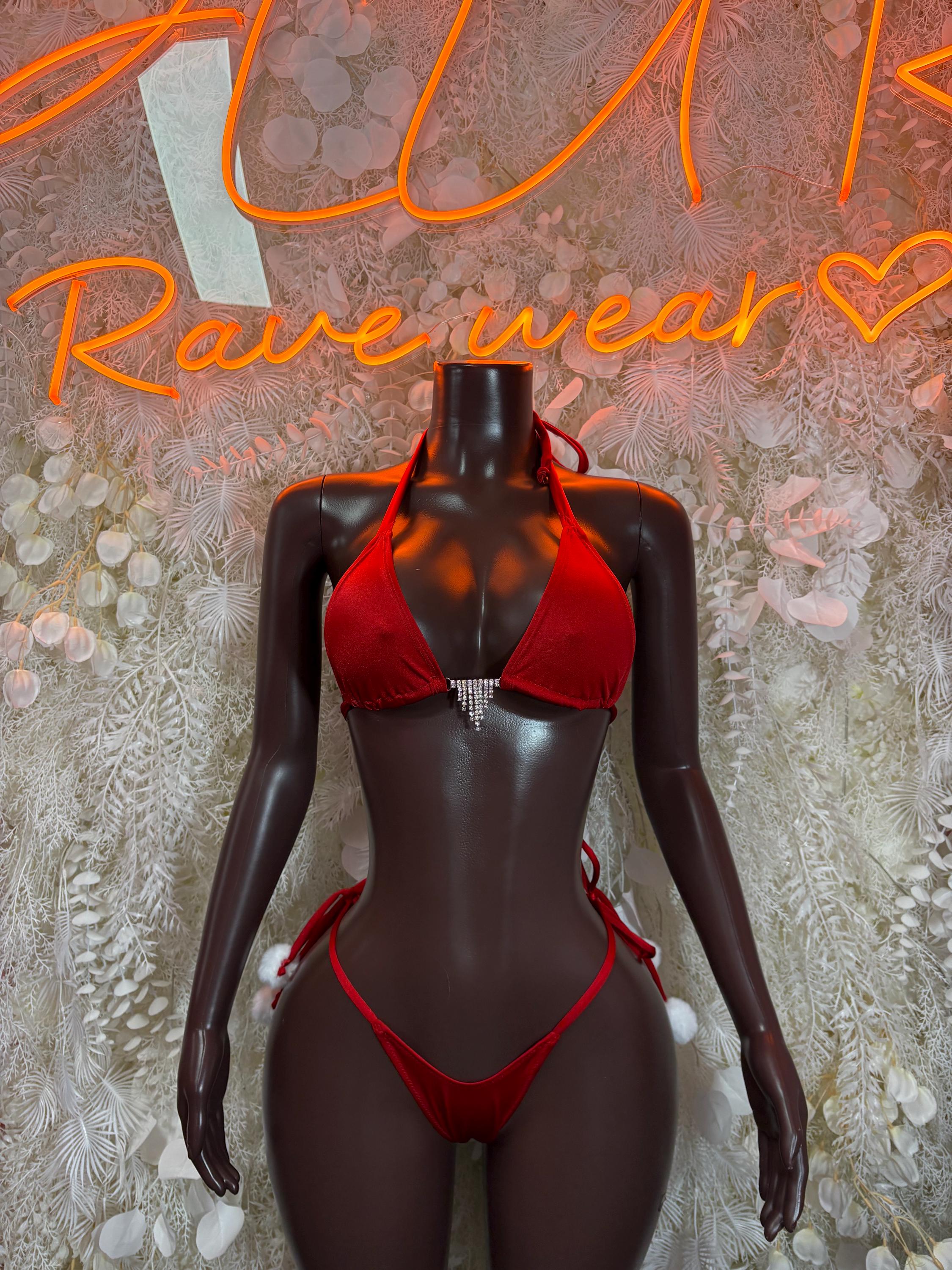 Red two-piece bikini set with triangle top and tie-string bottoms on dark mannequin