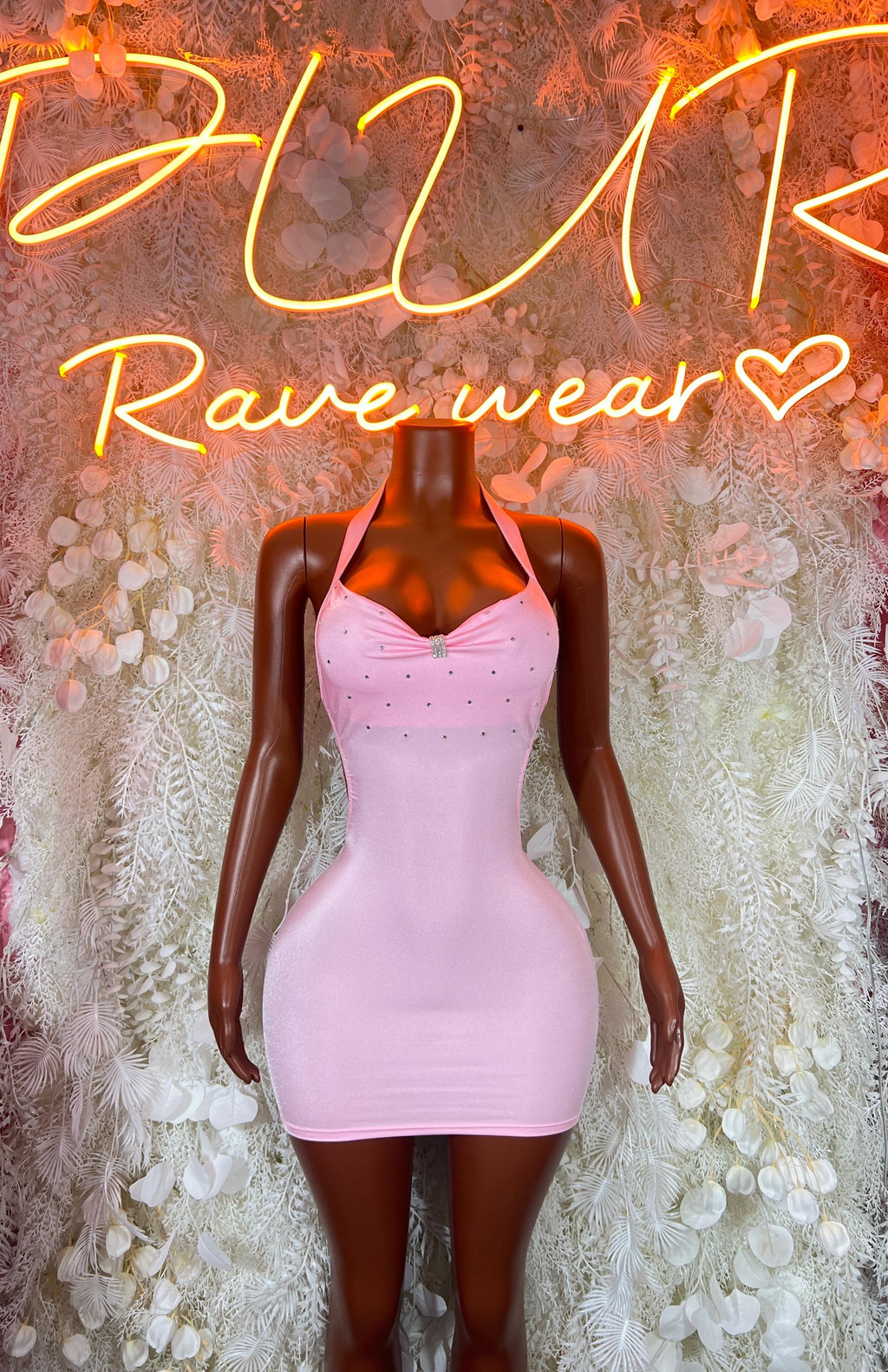 Pink mini bodycon dress with deep V neckline and backless cut
