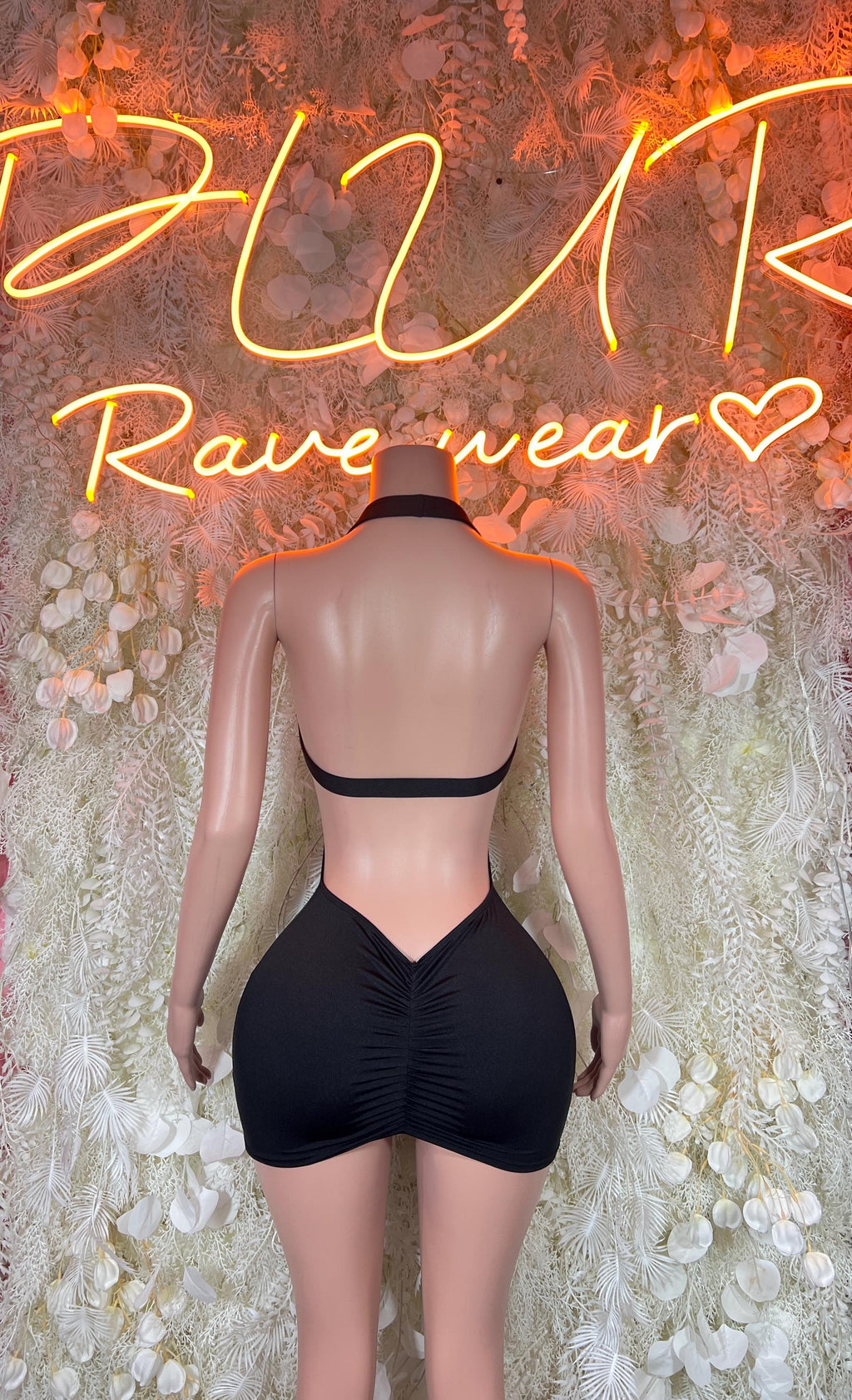 Black mini dress, sleeveless with open back and V-shaped lower back