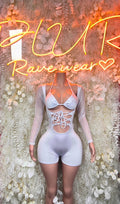 White long-sleeve lace-up bodysuit with chest cutout and shorts-style bottom