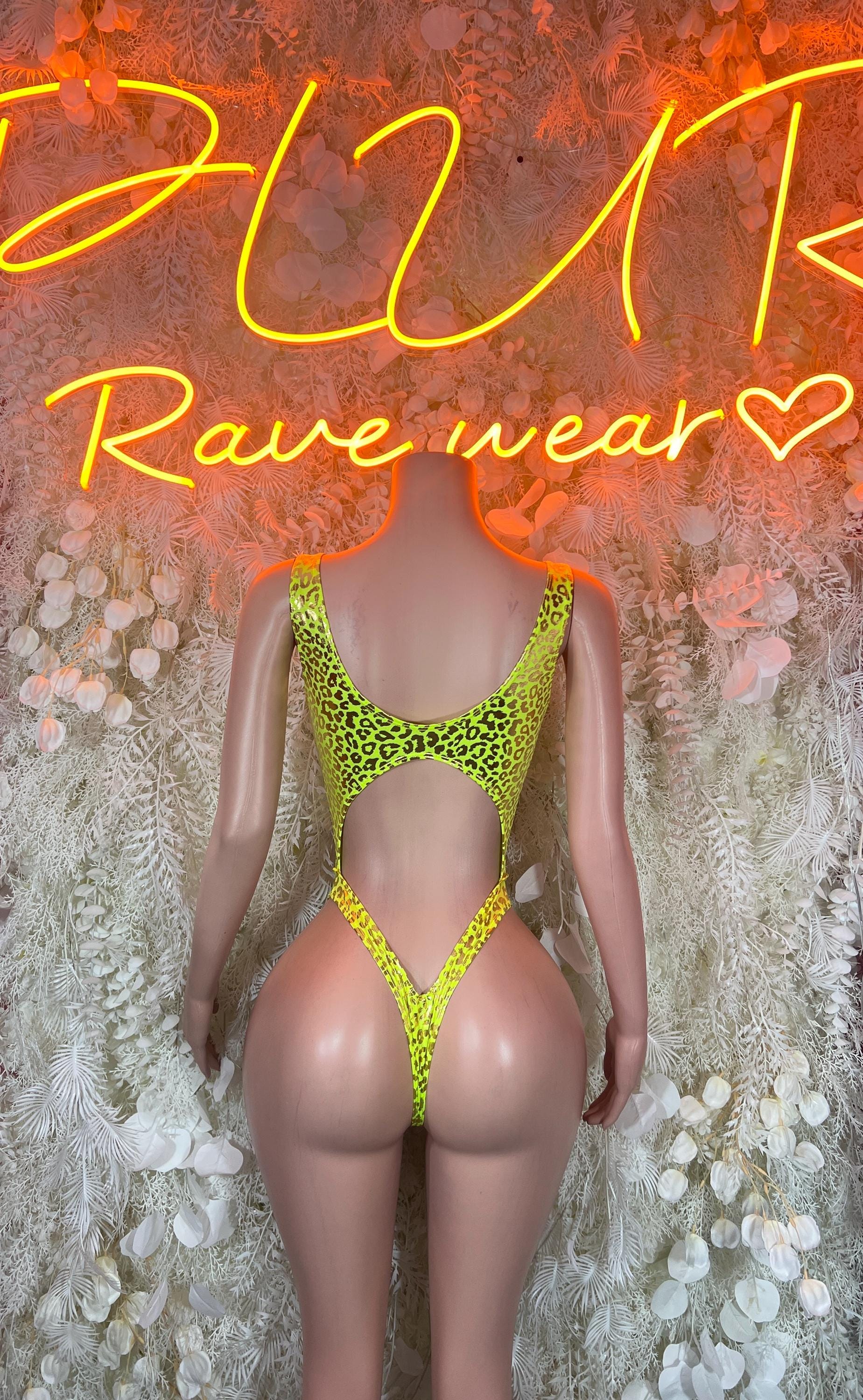 Neon green cheetah print bodysuit with cutout center and back straps