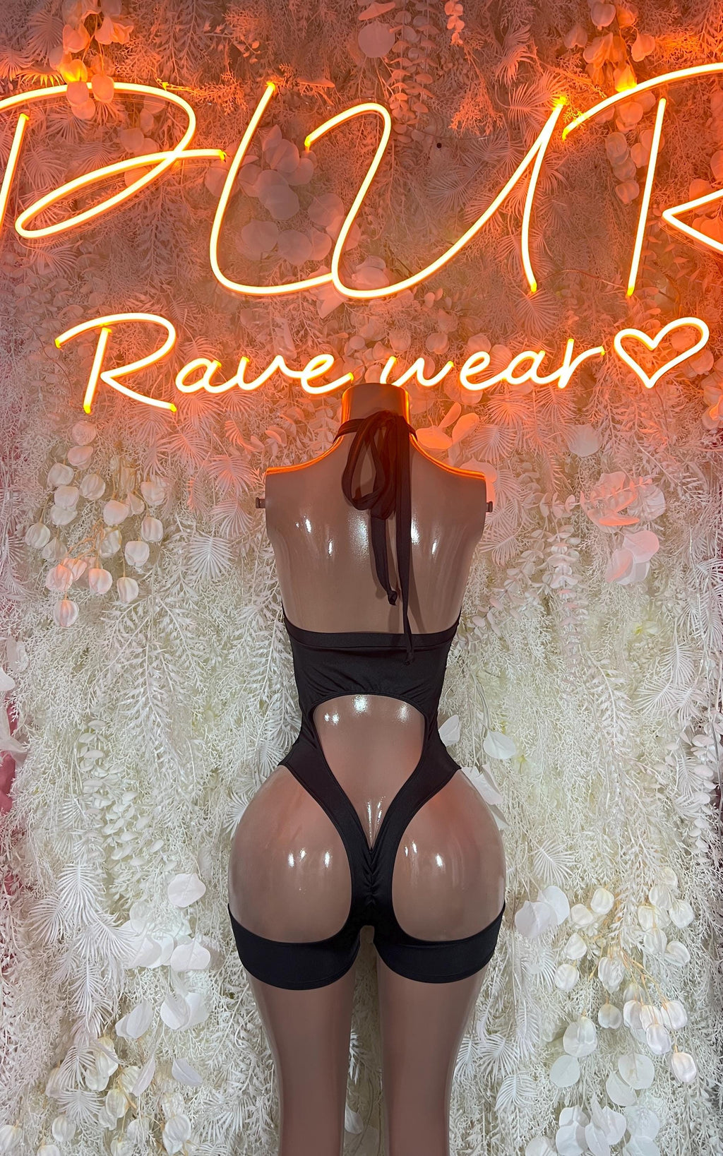 Black fishnet bodysuit back view with cutout straps and high-leg bottoms