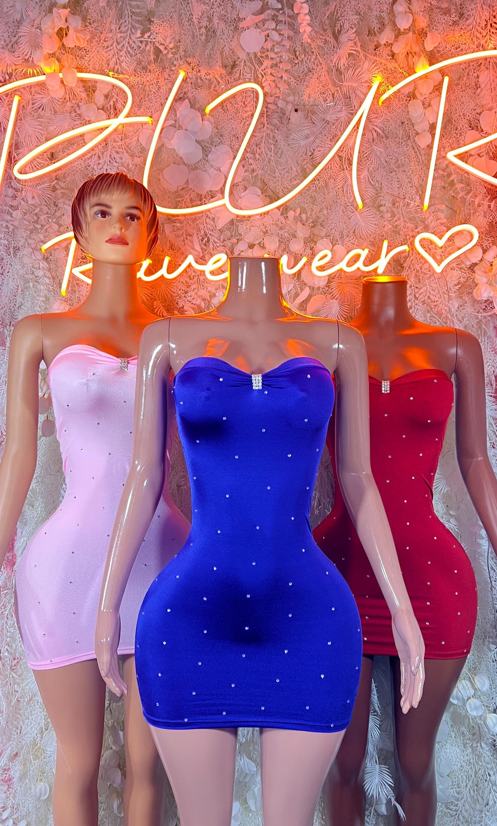 Three bodycon mini dresses: white, blue, and red with sweetheart necklines
