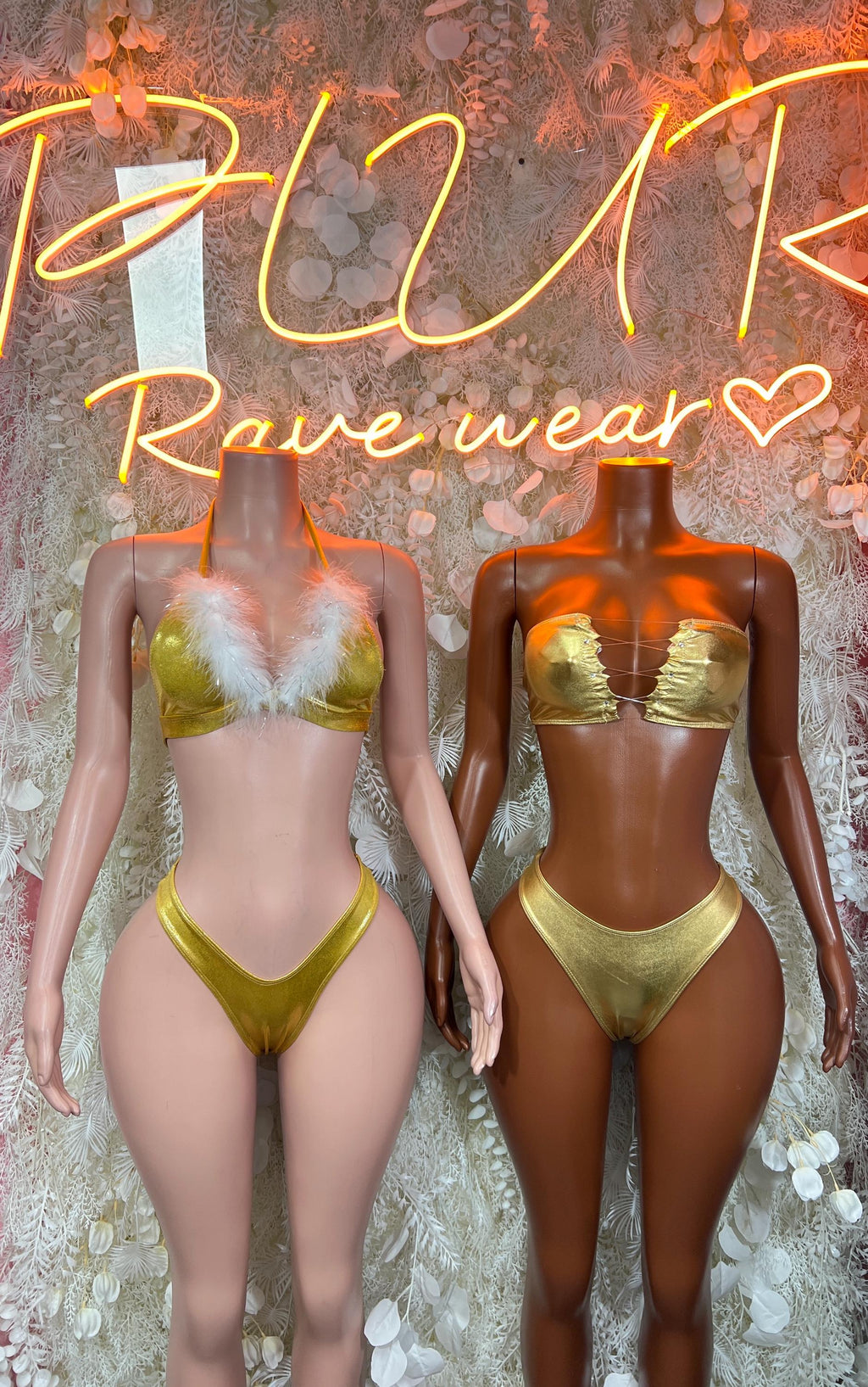 Gold metallic two-piece dance outfit on two models: feather-trim bra and bottoms