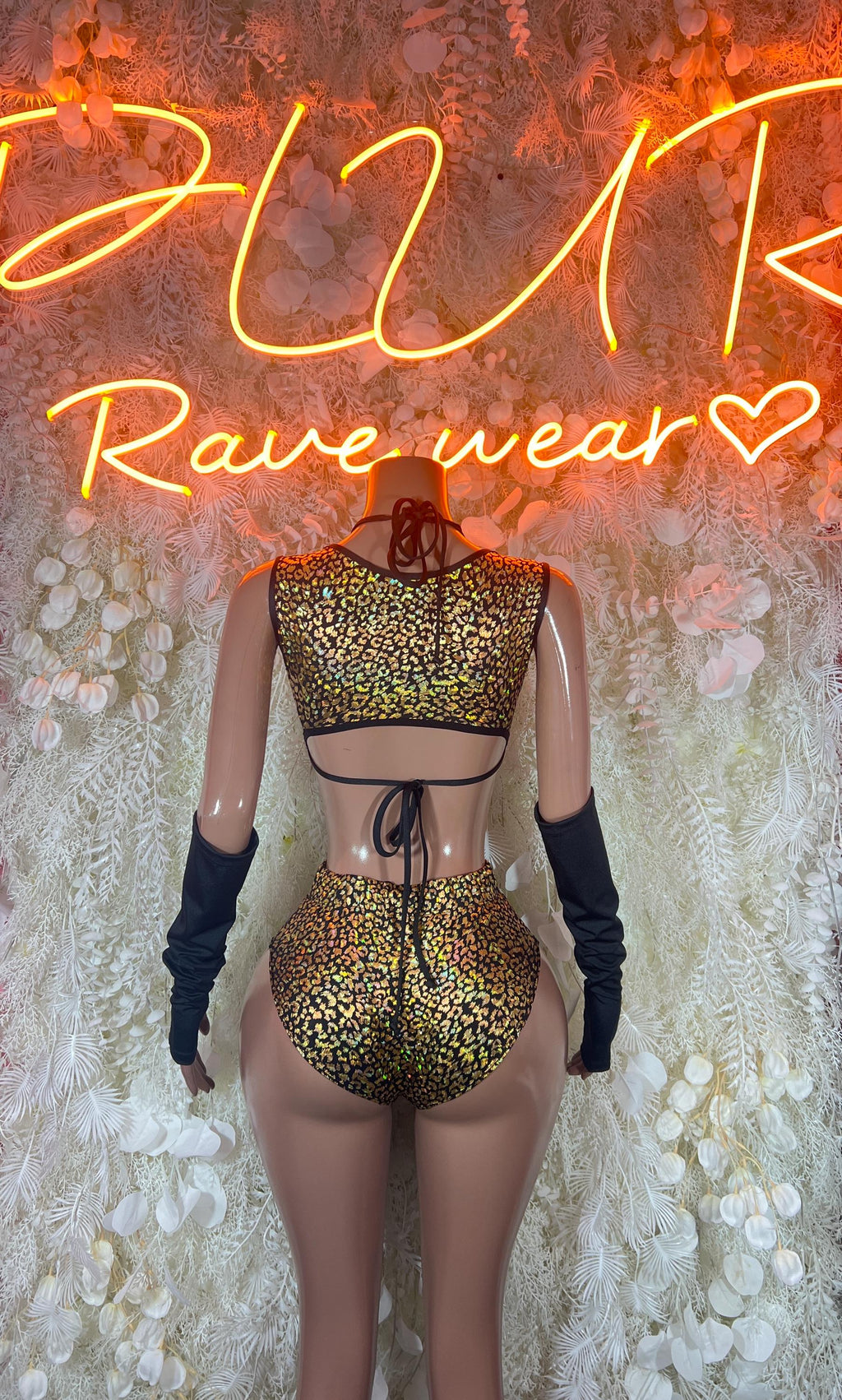 Cheetah-print rave bodysuit with adjustable front tie and black arm warmers
