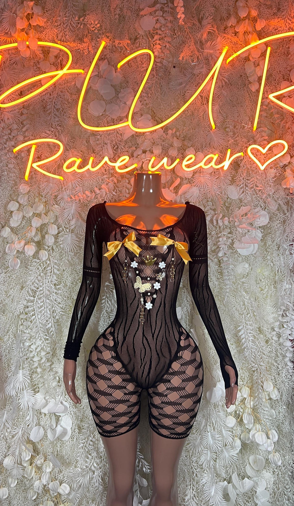 Black fishnet long-sleeve bodysuit with sheer panels and high-cut shorts