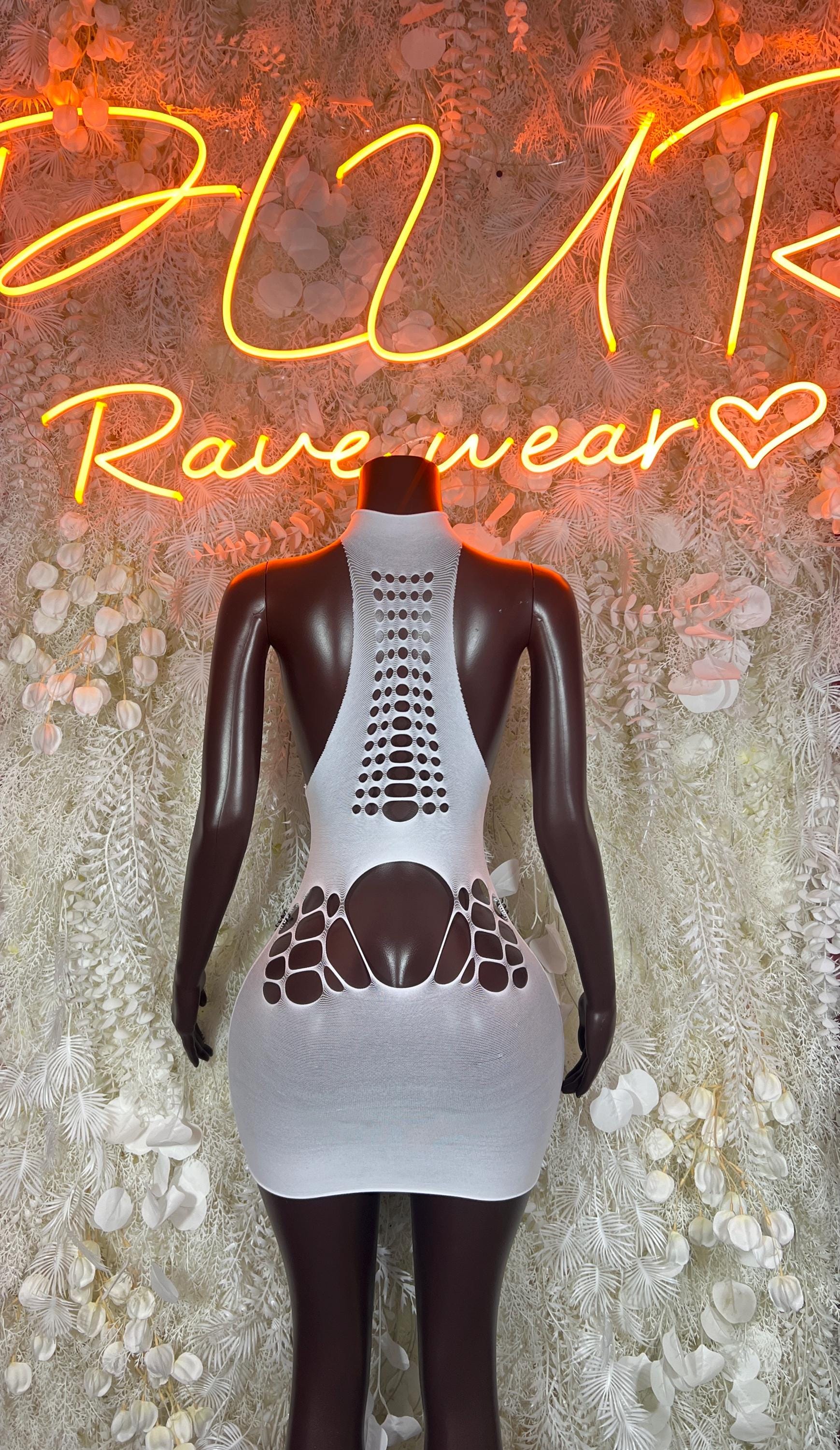 White fishnet bodysuit with vertical cutout pattern and short fitted skirt