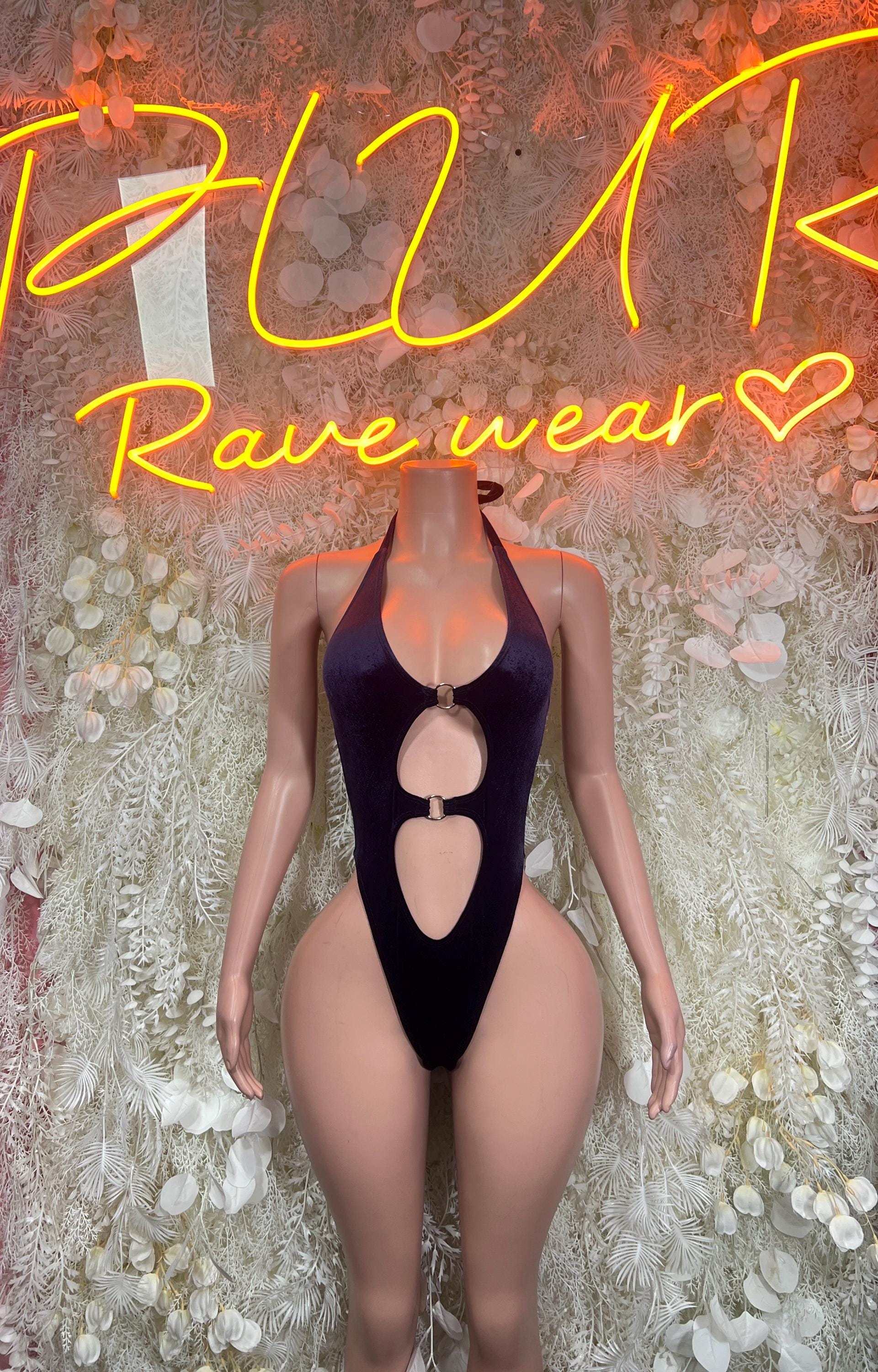 Purple velvet bodysuit with deep cutouts and oval ring detail