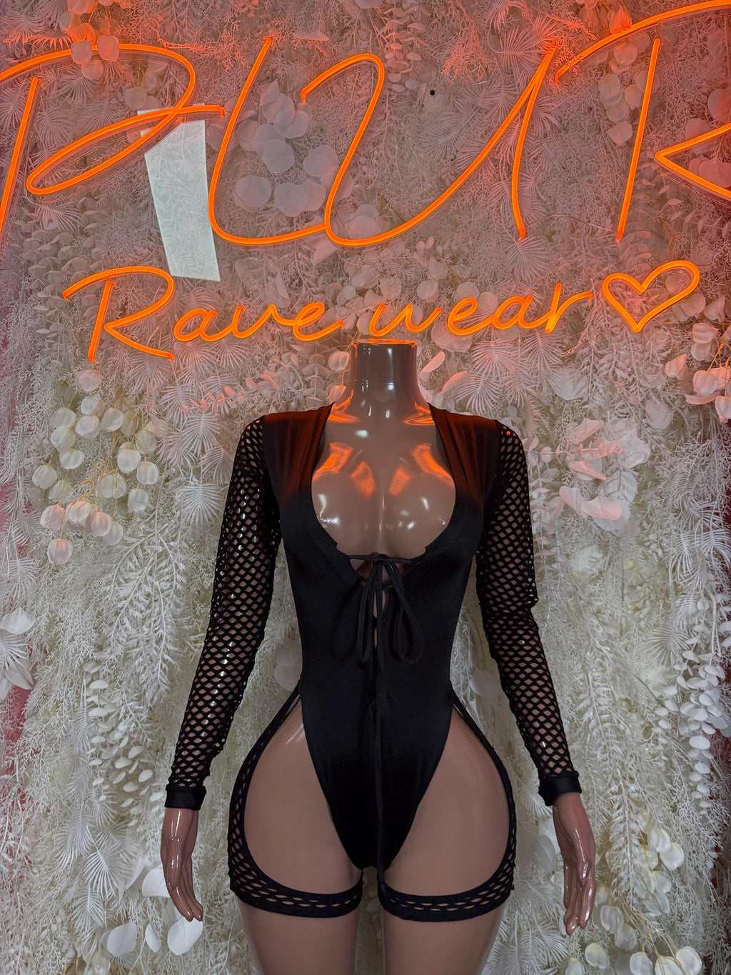 Black tie-front bodysuit with sheer mesh sleeves and high-cut leg openings
