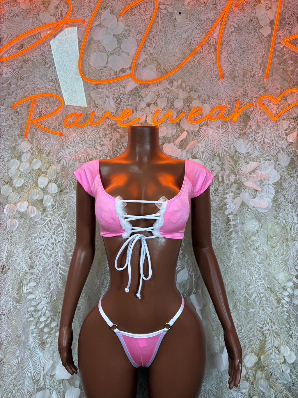 Pink two-piece bikini costume with off-shoulder tie top and matching thong bottom
