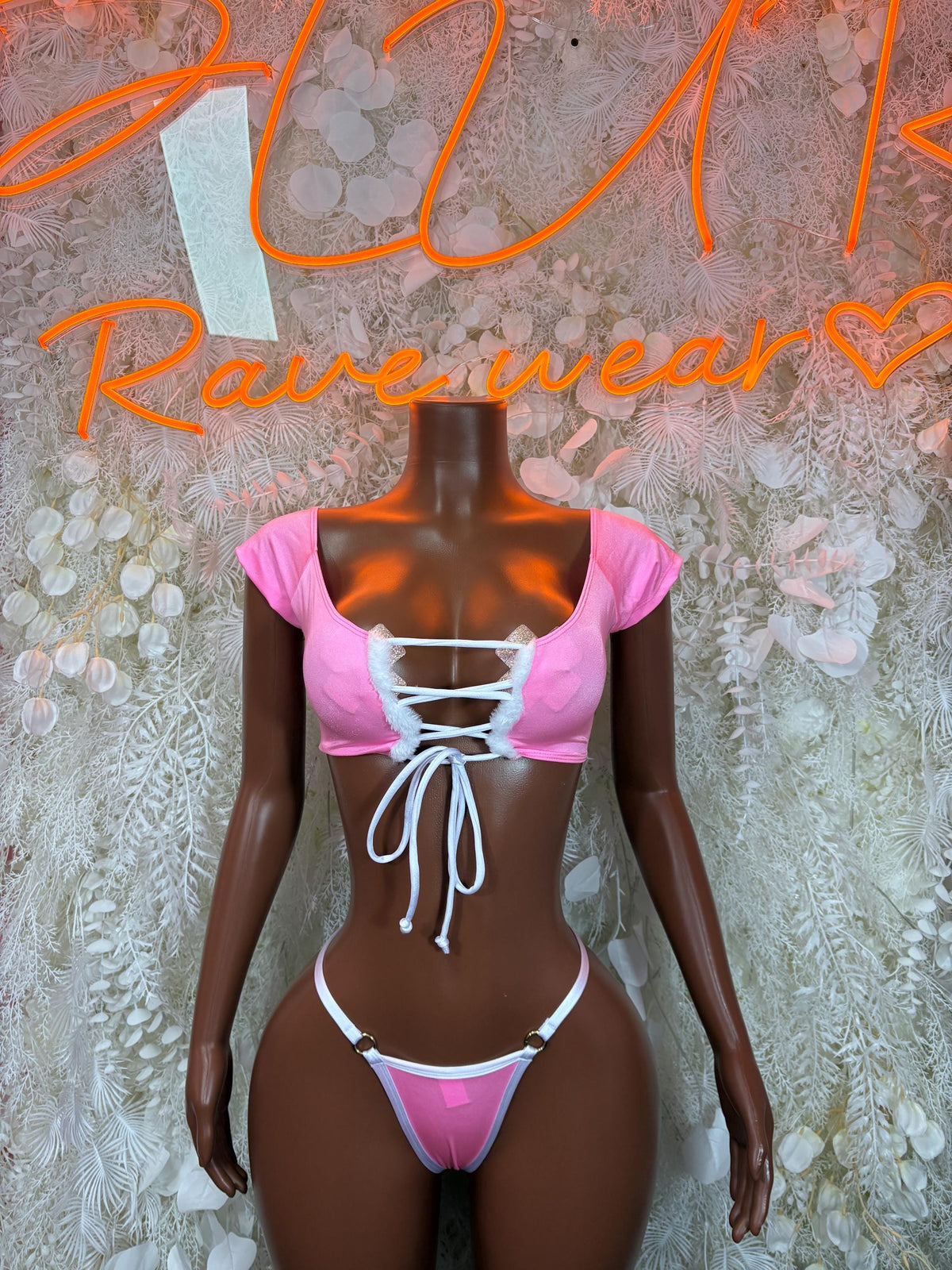Pink two-piece bikini costume with off-shoulder tie top and matching thong bottom