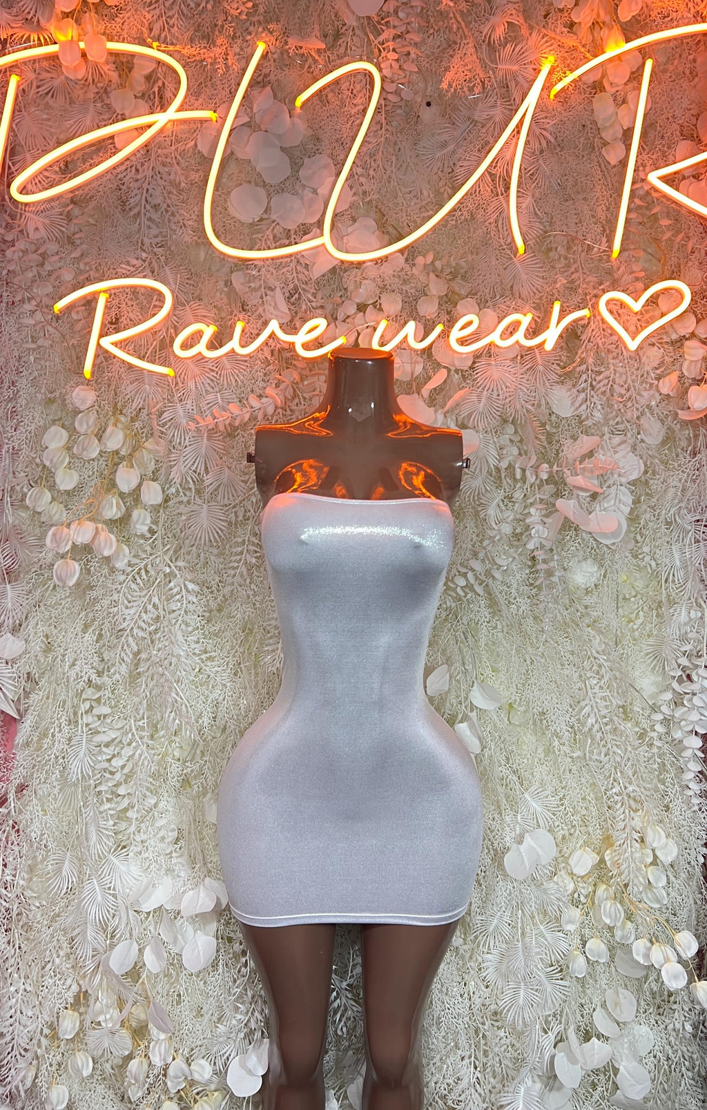Silver metallic fitted mini dress on mannequin, sleeveless with sweetheart neckline