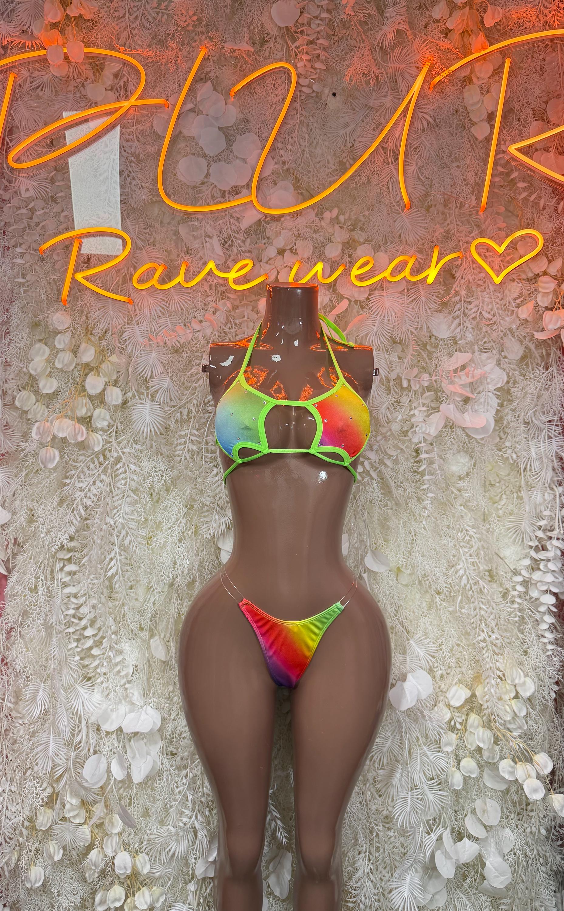 Women's rainbow rave bikini set on mannequin, neon green trim triangle top and thong bottoms