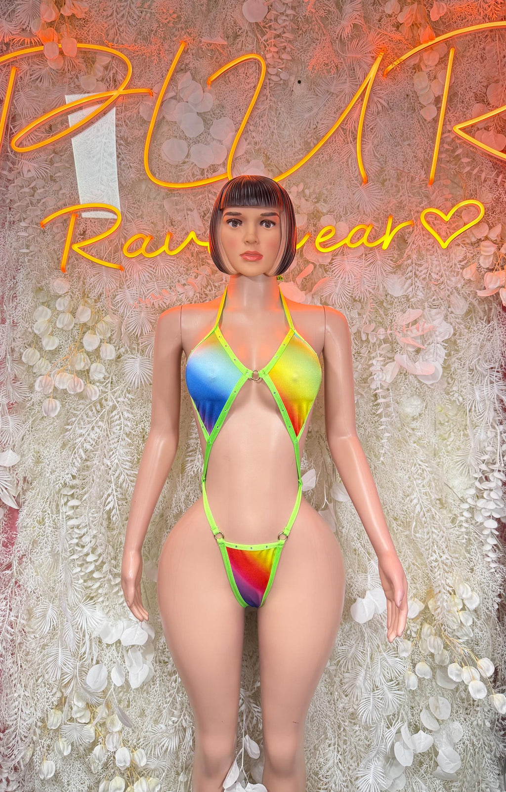 Multicolor one-piece bodysuit with neon green trim and rainbow triangle cutouts