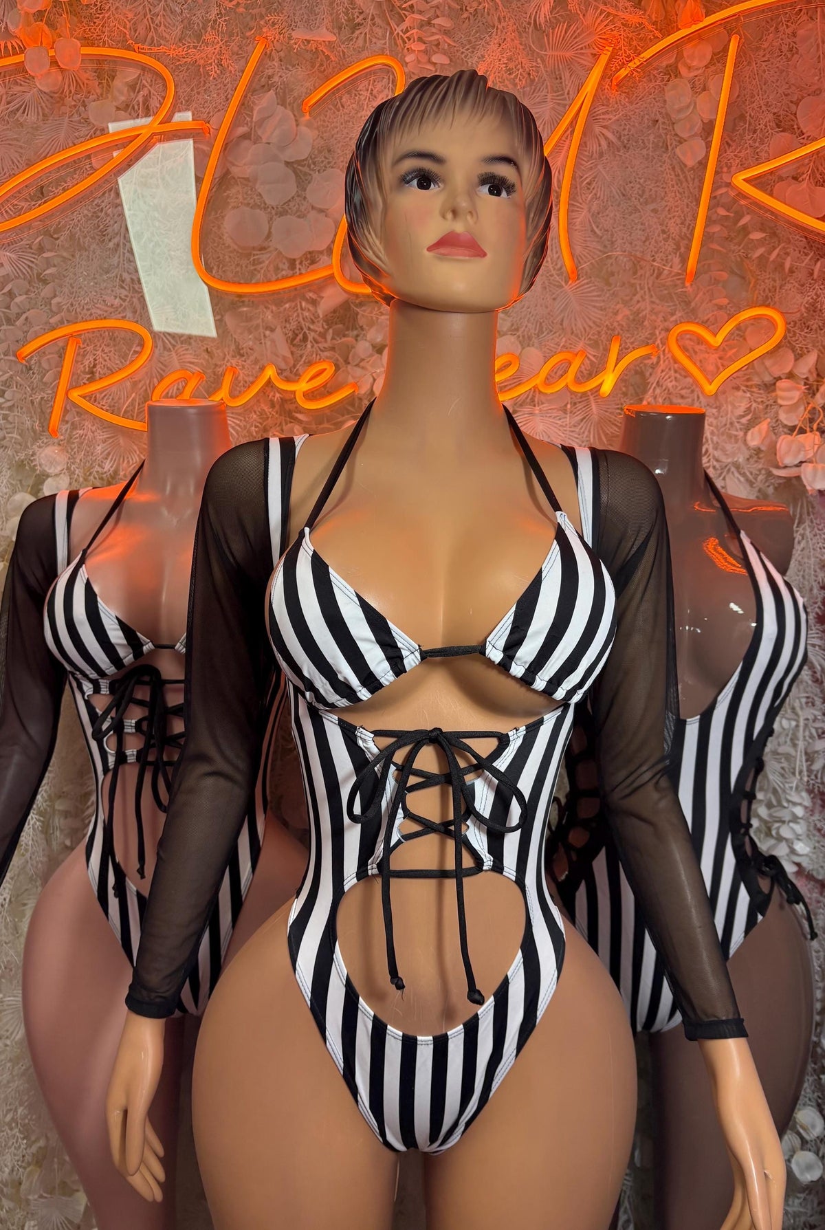 Black and white striped sheer bodysuit with mesh sleeves and lace-up centerpiece