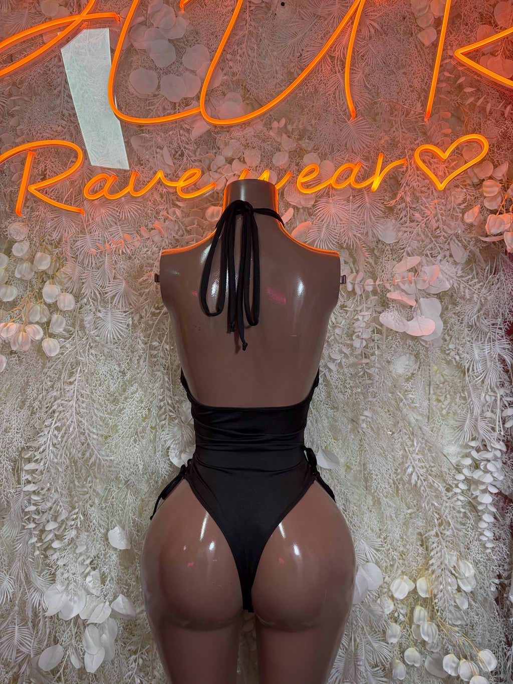 Black sheer back view bodysuit with black-and-white vertical stripes and tie detail