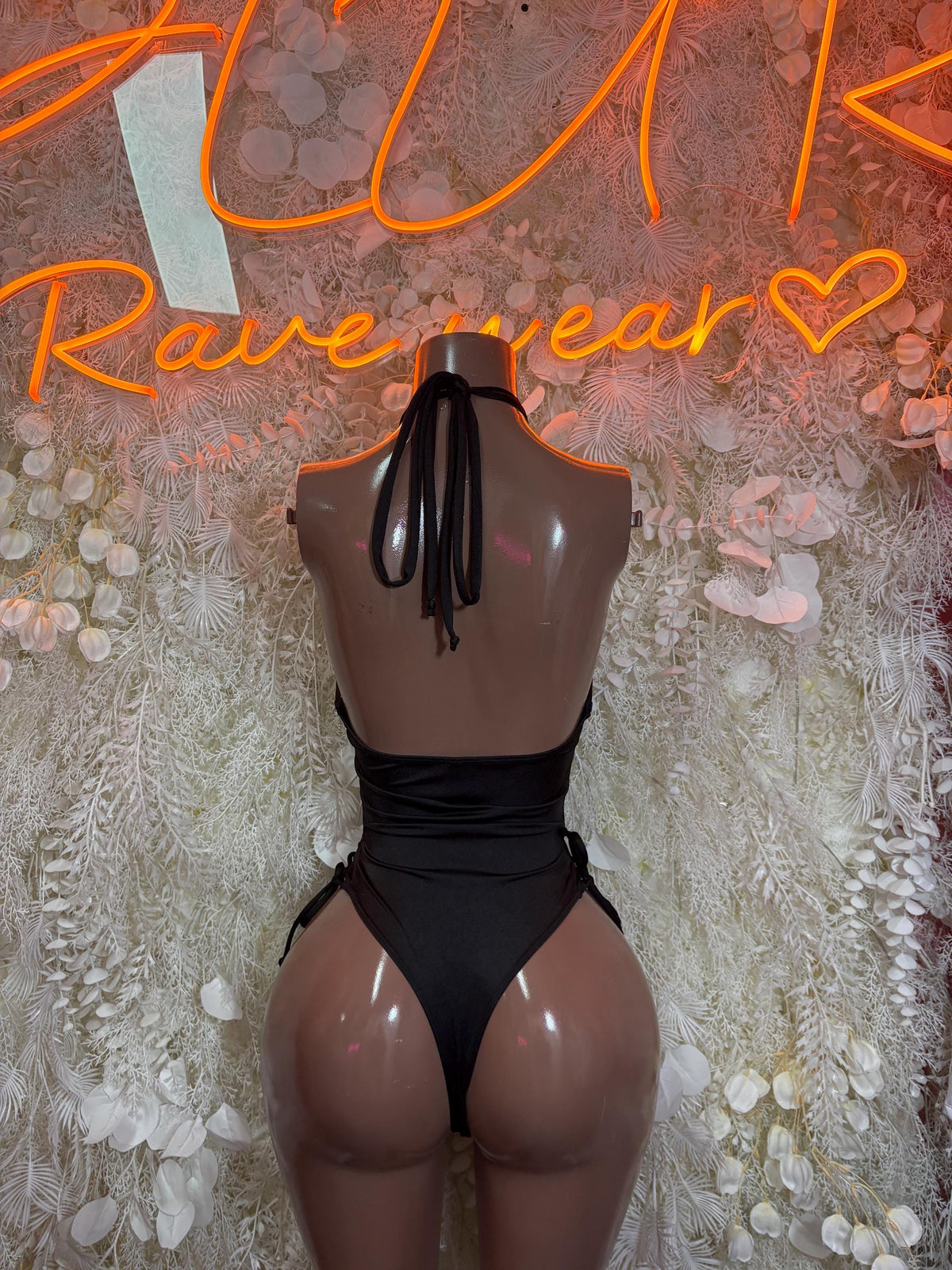 Black sheer back view bodysuit with black-and-white vertical stripes and tie detail
