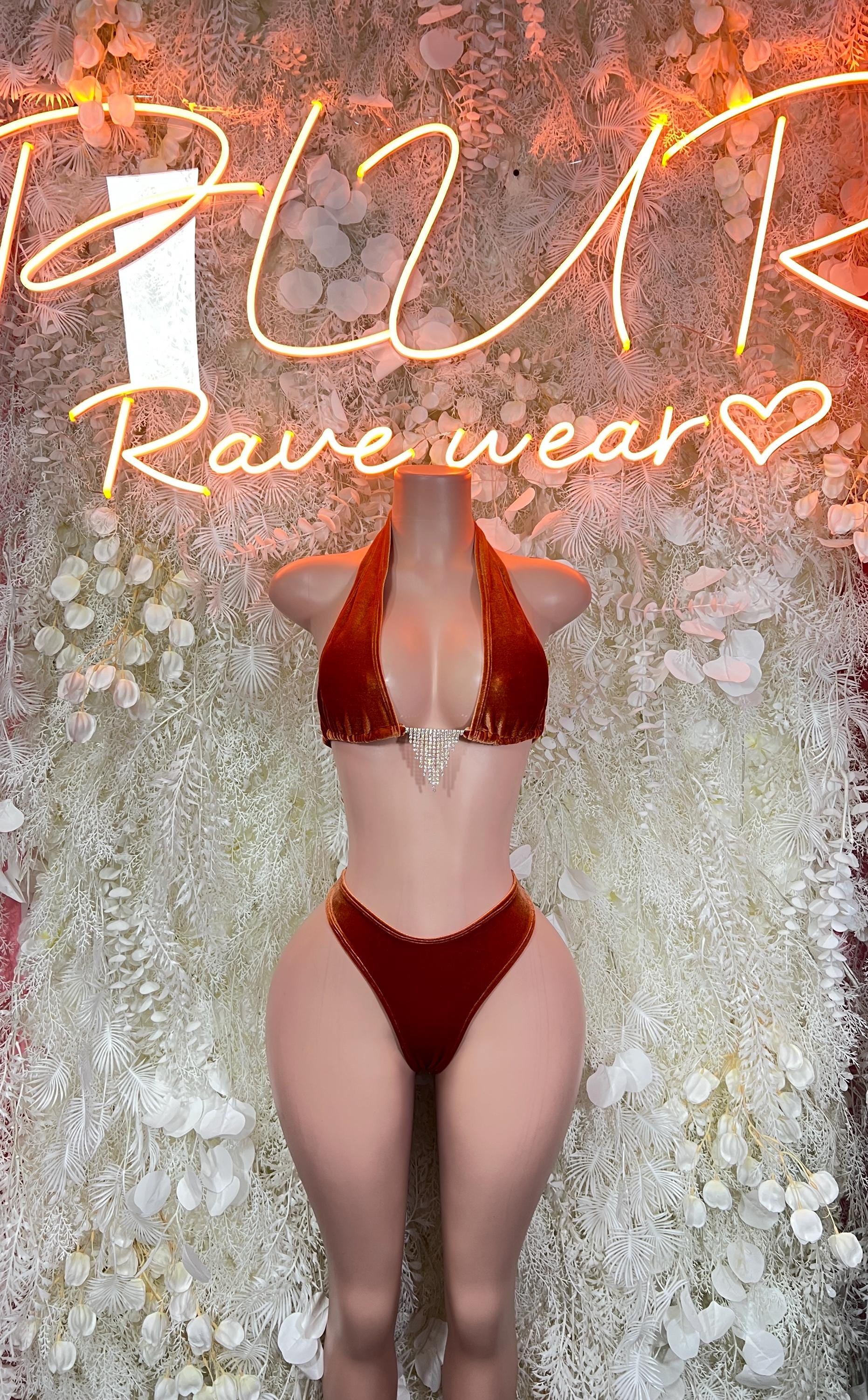 Metallic orange two-piece rave outfit with cropped bra top and high-rise thong bottoms